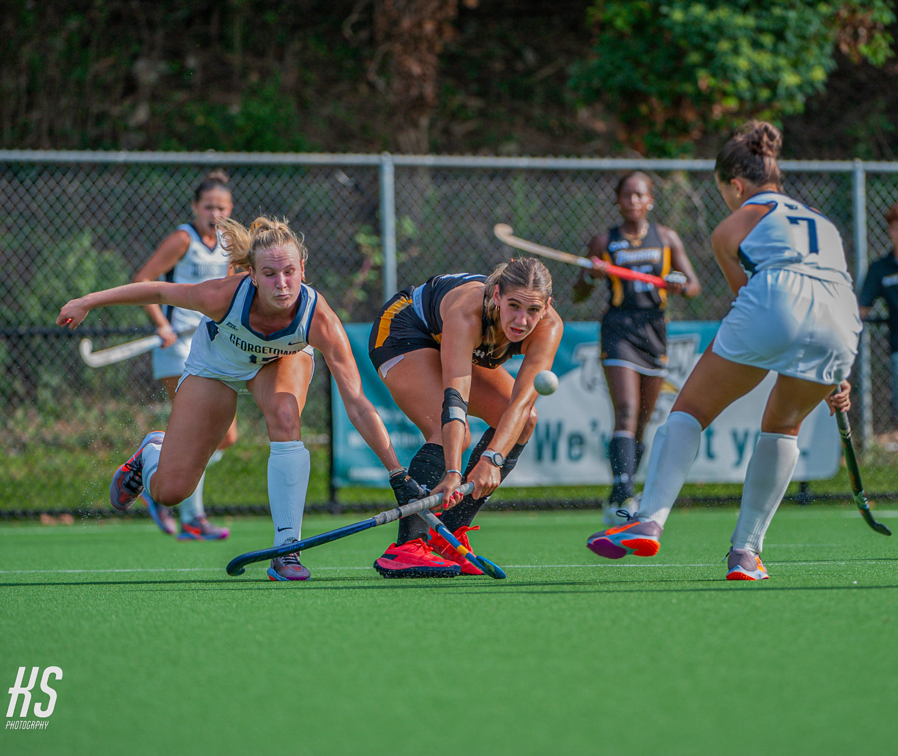 Towson University Field Hockey forward Kristin Strijdom attempts a difficult pass while tightly guarded by two Georgetown University defenders during the game at Towson University's Field Hockey Stadium in Towson, MD, on September 13, 2024.