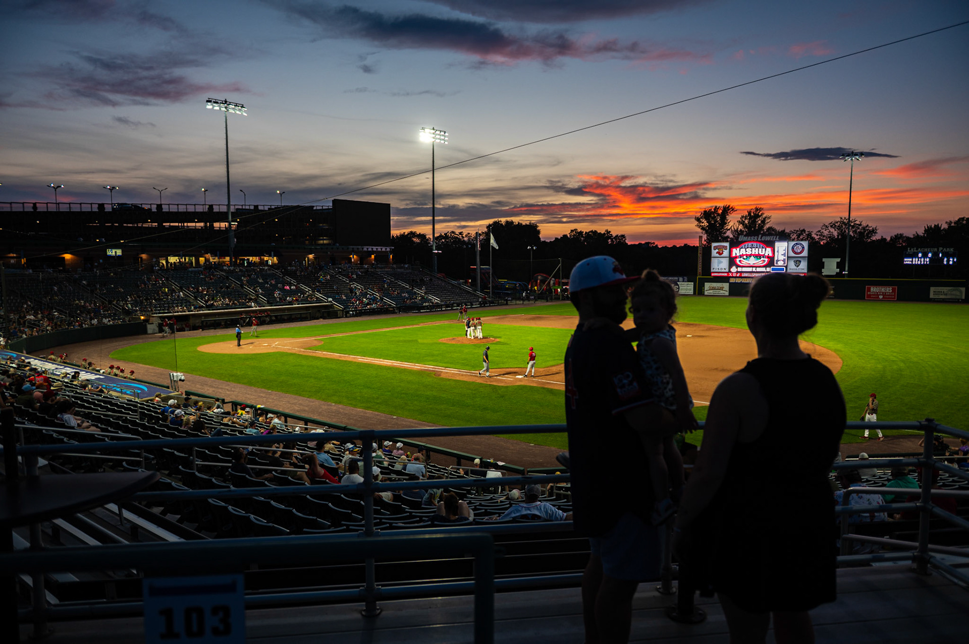 A young family watches the Lowell Spinners game the stands while enjoying the sunset. The game was played at Edward A. LeLacheur Park in Lowell, MA, on July 3rd, 2026.