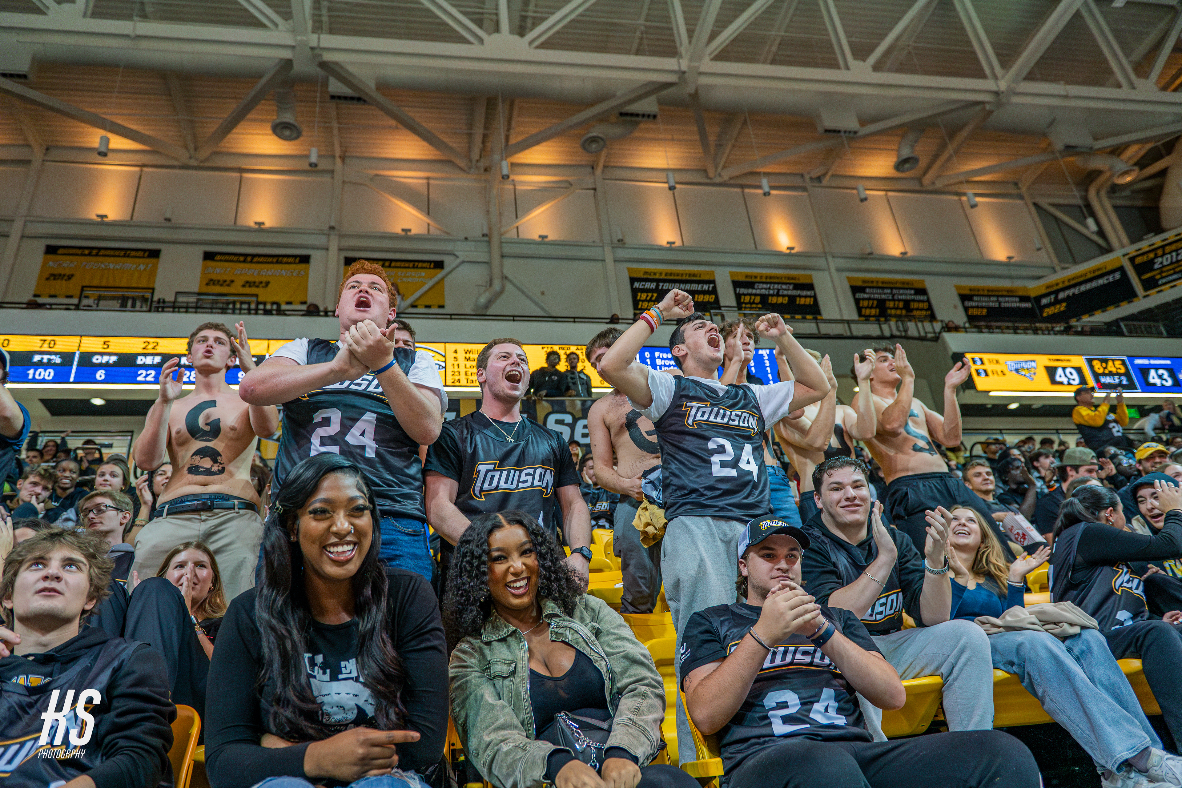 The Towson University student section cheers on their men's basketball team after a critical point in Towson's game against former rival James Madison University during the game at TU Arena in Towson, MD, on November 16, 2024.