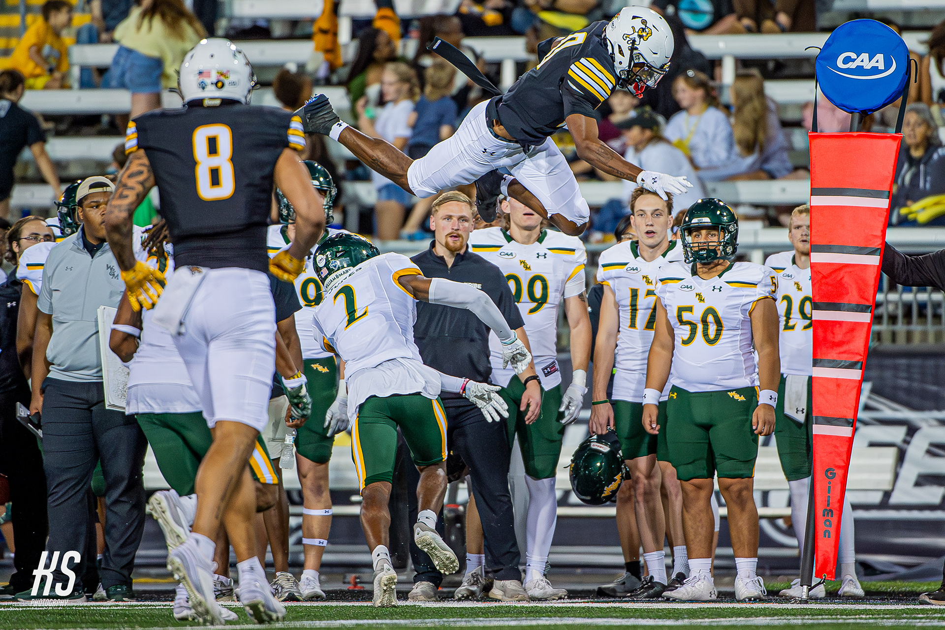 Towson University Football wide receiver John Dunmore leaps over cornerback Jalen Jones of 10th-ranked College of William & Mary during the NCAA Division I Football Championship Subdivision game at Unitas Stadium in Towson, MD, on October 5, 2024.