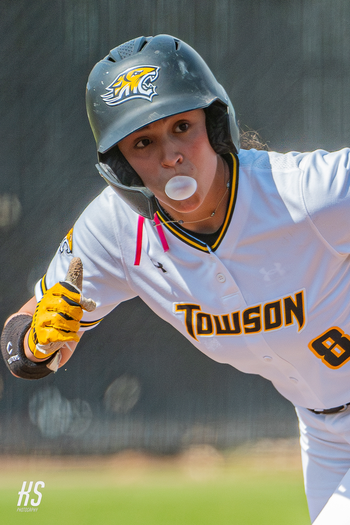 Towson Softball player Jenna Giattino gives a thumbs up while popping a piece of bubble gum at second base during the game at Towson University’s Softball Complex on April 18, 2025.