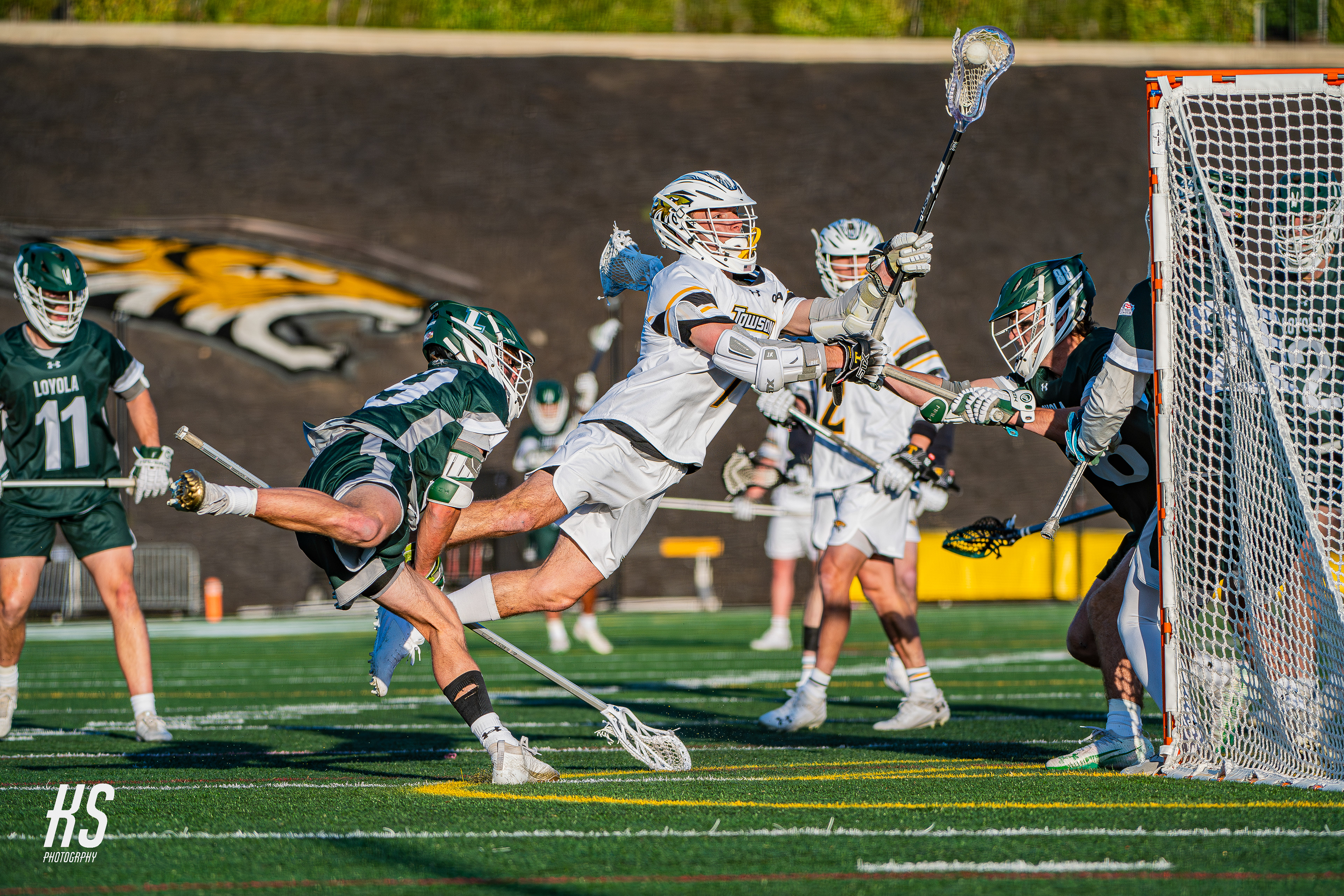 Towson midfielder Mikey Weisshaar takes a diving shot against historic Baltimore rival Loyola College of Maryland at Unitas Stadium in Towson on April 8, 2025.