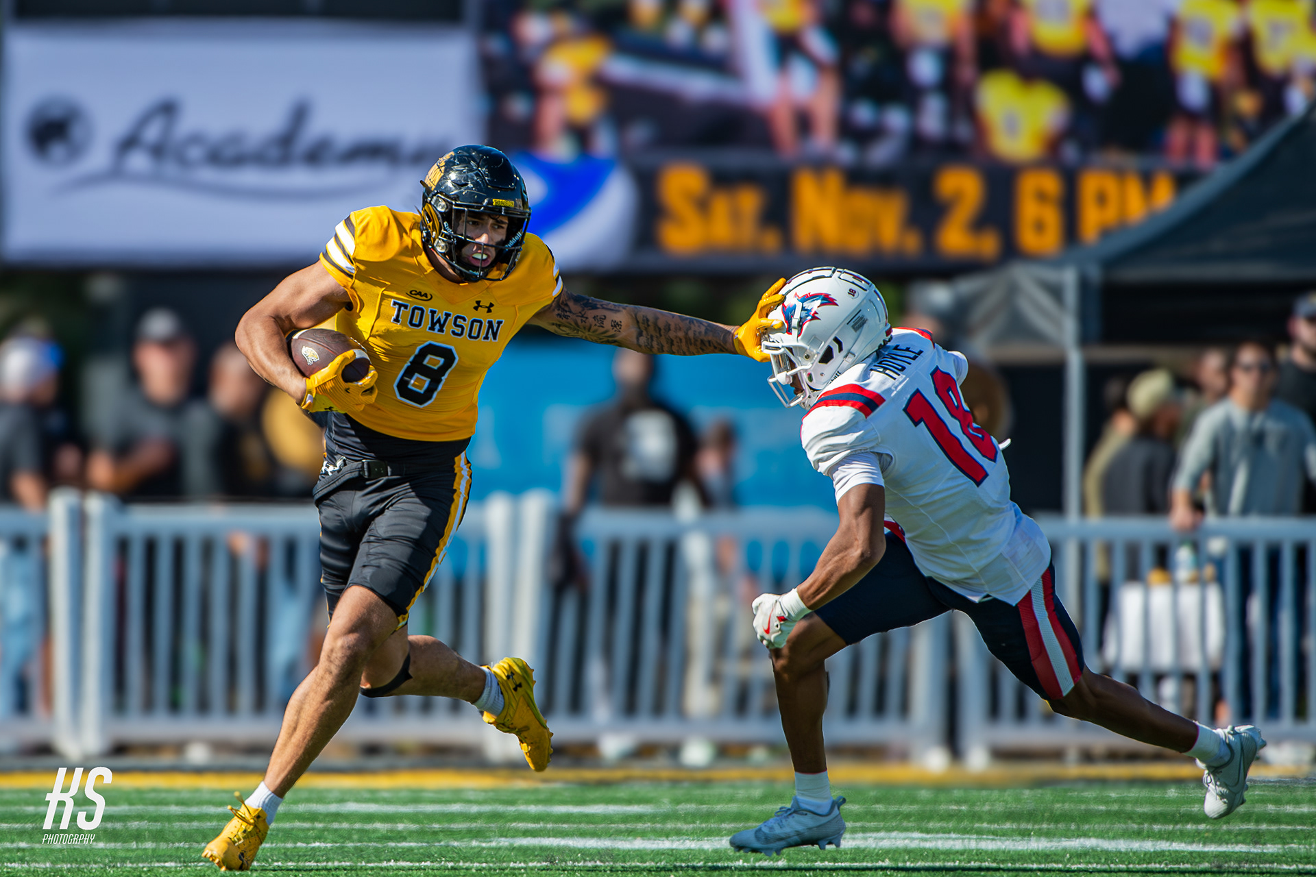 Towson University Football tight end Carter Runyon stiff-arms Stony Brook University defensive back Jalen Hoyle during the game at Unitas Stadium in Towson, MD, on October 19, 2024.