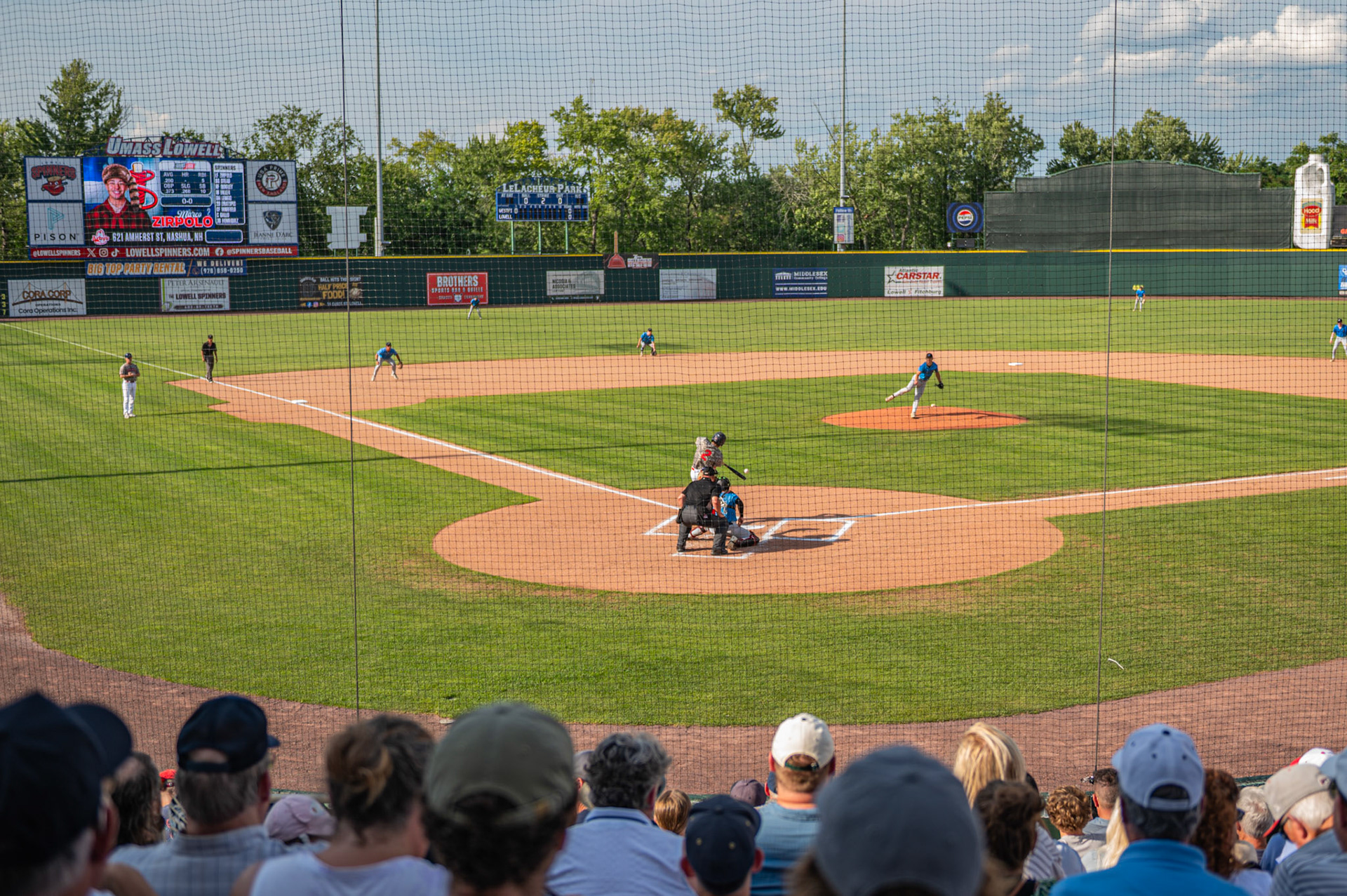 Many fans watch as Marco Zirpolo gets a hit against the Westfield Starfires pitcher. The game was played at Edward A. LeLacheur Park, in Lowell, MA, on August 1st, 2026.