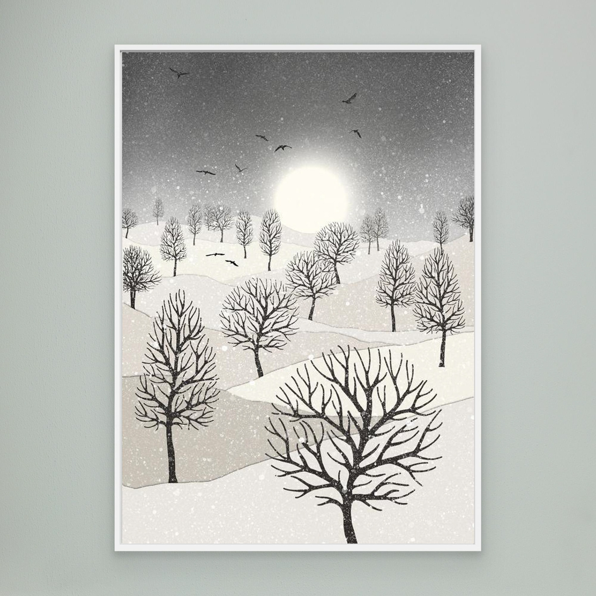 Winter Sun, artwork created by Robbie William for WalkinHISlight, depicting snow falling on a landscape dotted with various trees with the sun shining in the background and birds flying. Reductive in nature. Shades of white, grey's through to black.. Available as a canvas print and paper print framed or unframed in various sizes. Contemporary/modern in style..