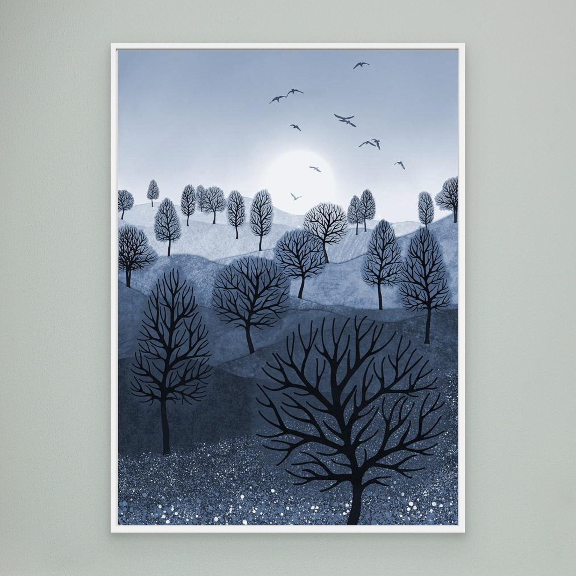 A Splash of Colour 'Blue' created by Robbie William for WalkinHISlight,, artwork depicting a landscape dotted with various trees with the sun shining in the background, with a field of flowers in the foreground and birds flying. Reductive in nature. Shades of white, blue,, through to black.  Available as a canvas print and paper print framed or unframed in various sizes. Contemporary/modern in style..