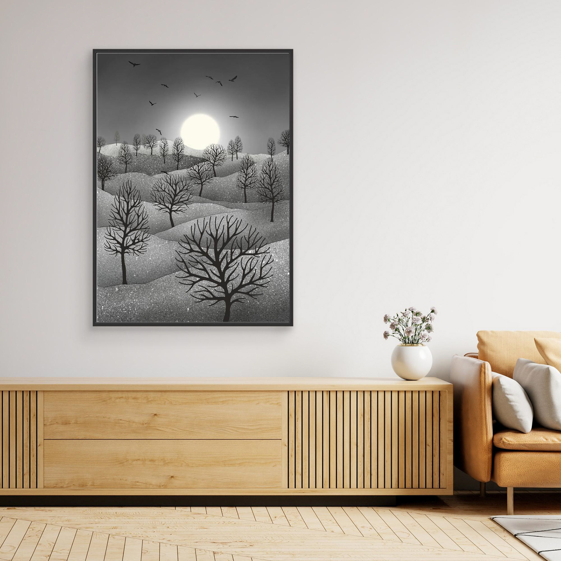 Winter Sparkles, artwork created by Robbie William for WalkinHISlight, depicting a landscape dotted with various trees with the sun shining in the background and birds flying. Reductive in nature. Shades of white, grey through to black.. Available as a canvas print and paper print framed or unframed in various sizes. Contemporary/modern in style..