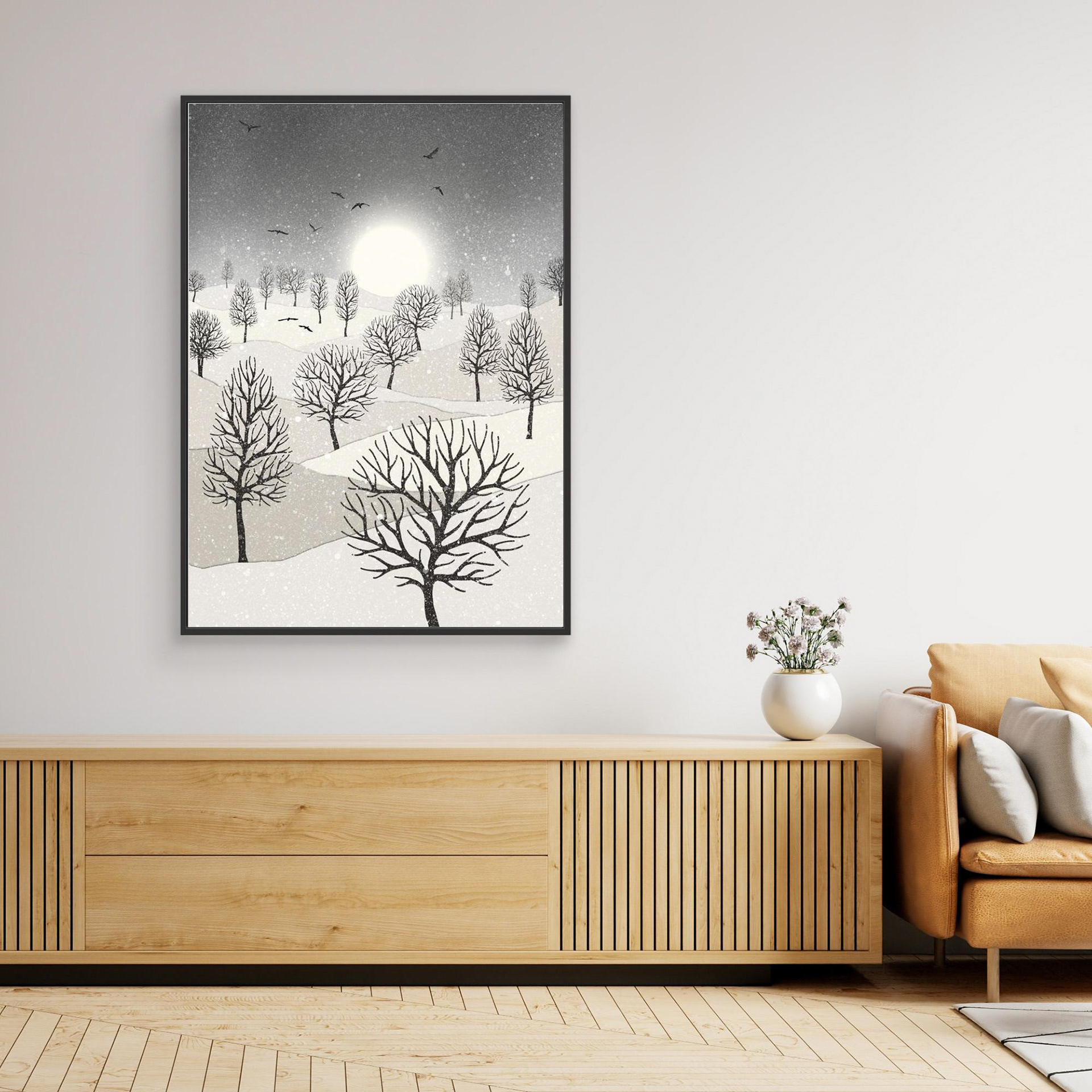 Winter Sun, artwork created by Robbie William for WalkinHISlight, depicting snow falling on a landscape dotted with various trees with the sun shining in the background and birds flying. Reductive in nature. Shades of white, grey's through to black.. Available as a canvas print and paper print framed or unframed in various sizes. Contemporary/modern in style..