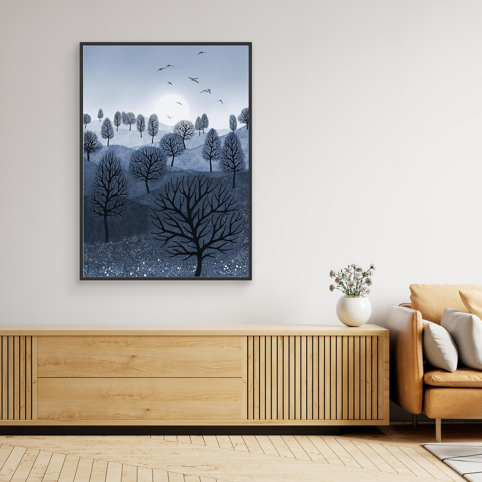 A Splash of Colour 'Blue' created by Robbie William for WalkinHISlight,, artwork depicting a landscape dotted with various trees with the sun shining in the background, with a field of flowers in the foreground and birds flying. Reductive in nature. Shades of white, blue,, through to black.  Available as a canvas print and paper print framed or unframed in various sizes. Contemporary/modern in style..