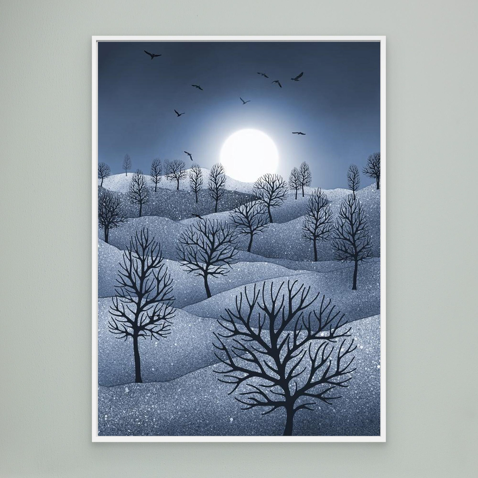 Winter Sparkles,'Blue' artwork created by Robbie William for WalkinHISlight, depicting a landscape dotted with various trees with the sun shining in the background and birds flying. Reductive in nature. Shades of white, blue through to black.. Available as a canvas print and paper print framed or unframed in various sizes. Contemporary/modern in style..