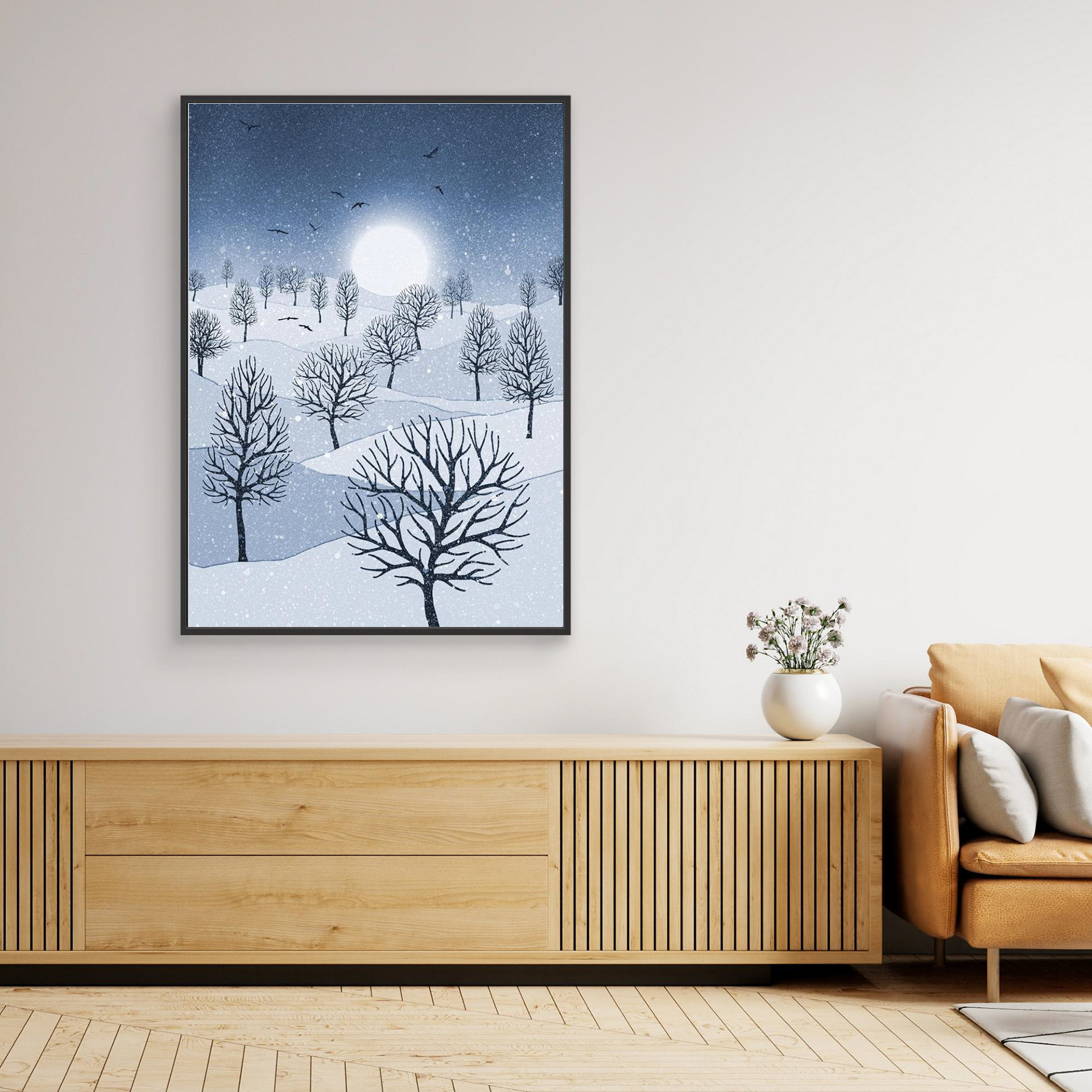 Winter Sun, artwork created by Robbie William for WalkinHISlight, depicting snow falling on a landscape dotted with various trees with the sun shining in the background and birds flying. Reductive in nature. Shades of white, blue through to black.. Available as a canvas print and paper print framed or unframed in various sizes. Contemporary/modern in style. 