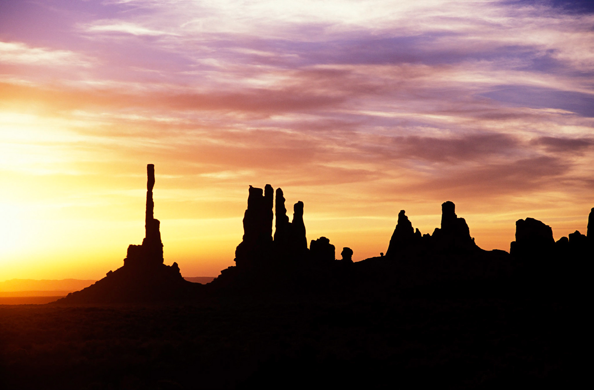 Sunrise behind Totem Pole and Yei Bi Chei, Monument Valley, Arizona / Utah