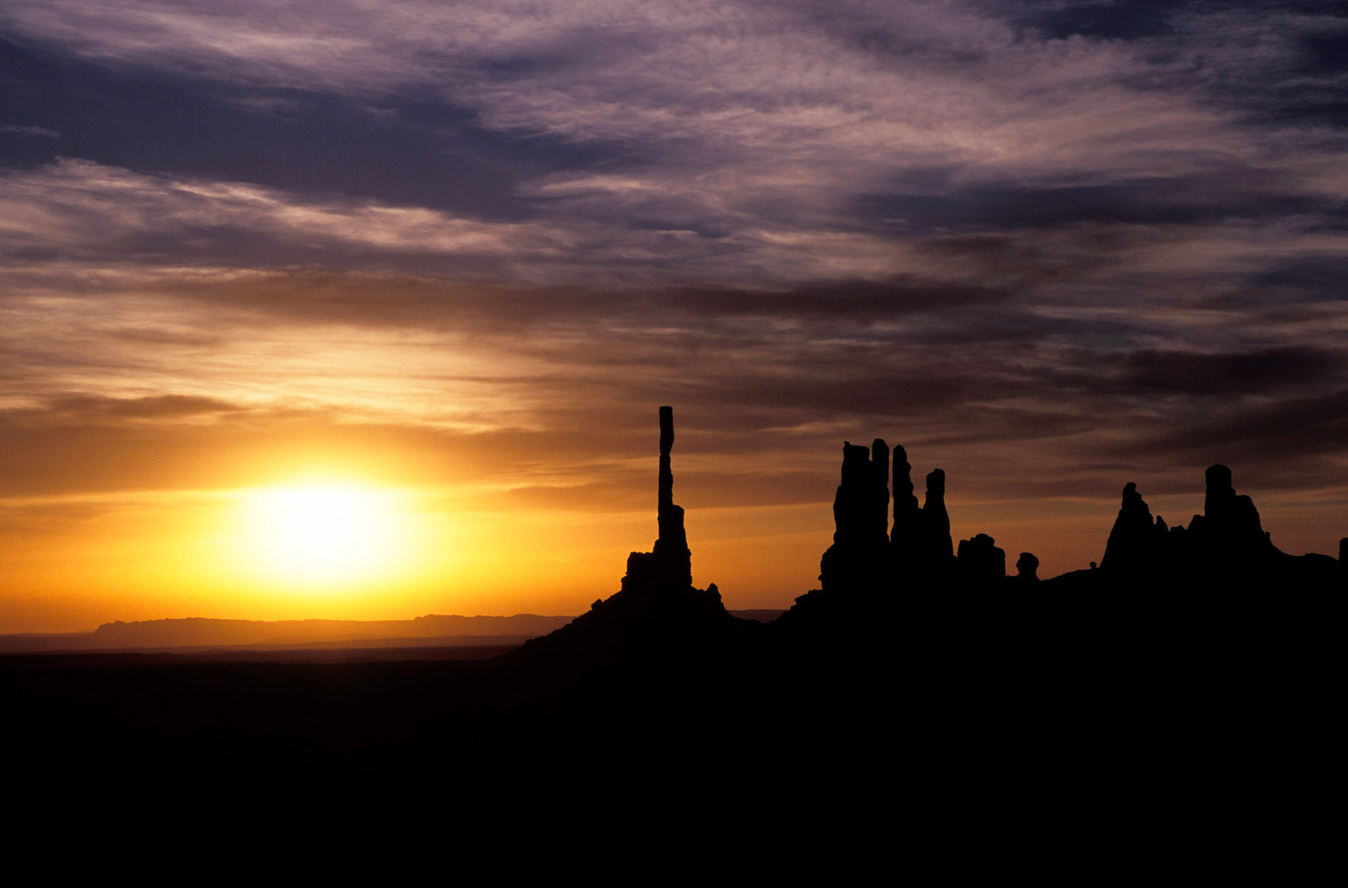 Sunrise behind Totem Pole and Yei Bi Chei, Monument Valley, Arizona / Utah