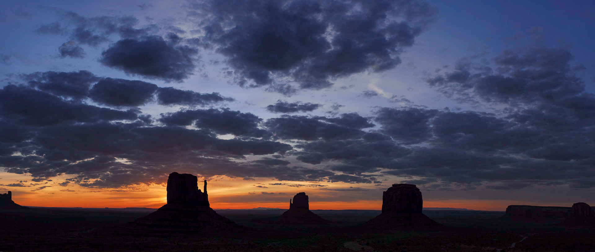 The Mittens and Merrick Butte at Sunrise (Panorama), Monument Valley, Arizona / Utah