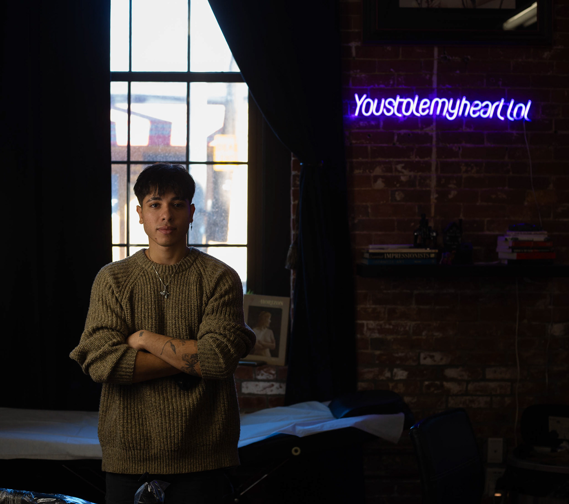 Kaiki Gomez, 20 y.o tattoo artist posing for a portrait in his previous studio — Body Art Studio 13, Framingham MA. Kai now works out of his home in Boston MA.