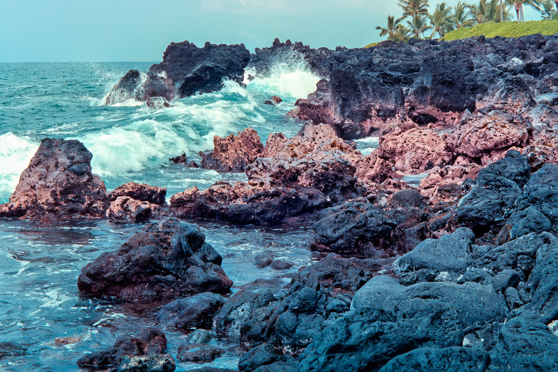 Waves break along the rugged coastline, remnant of ancient lava flows, located north of the Kamakahonu National Historic Landmark in Kailuna -Kona, Hawaii.Image captured on Kodak Royal Gold 100 color negative film. After scanning it with an Epson Perfection V750 PRO using Silverfast software, the ColorPerfect Plugin from CFSystems converted the negative image to a positive image in Photoshop. Post-processing completed in Lightroom Classic.