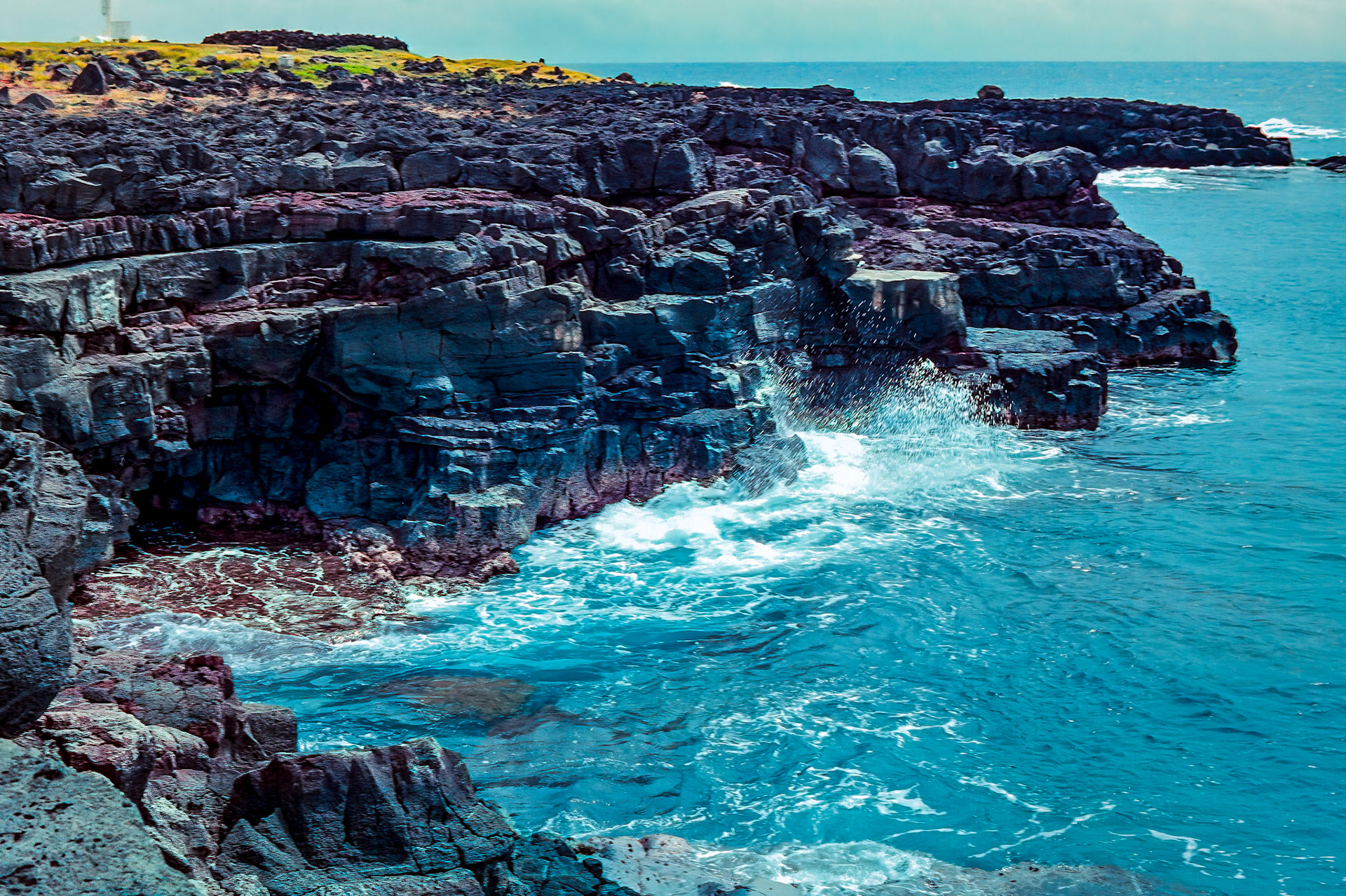 Years of Pacific Ocean waves and weather pounding the old lava fields of Mona Loa created these formidable cliffs along the Ka Lae coast.Image captured on Kodak Royal Gold 100 color negative film. After scanning it with an Epson Perfection V750 PRO using Silverfast software, the ColorPerfect Plugin from CFSystems converted the negative image to a positive image in Photoshop. Post-processing completed in Lightroom Classic.
