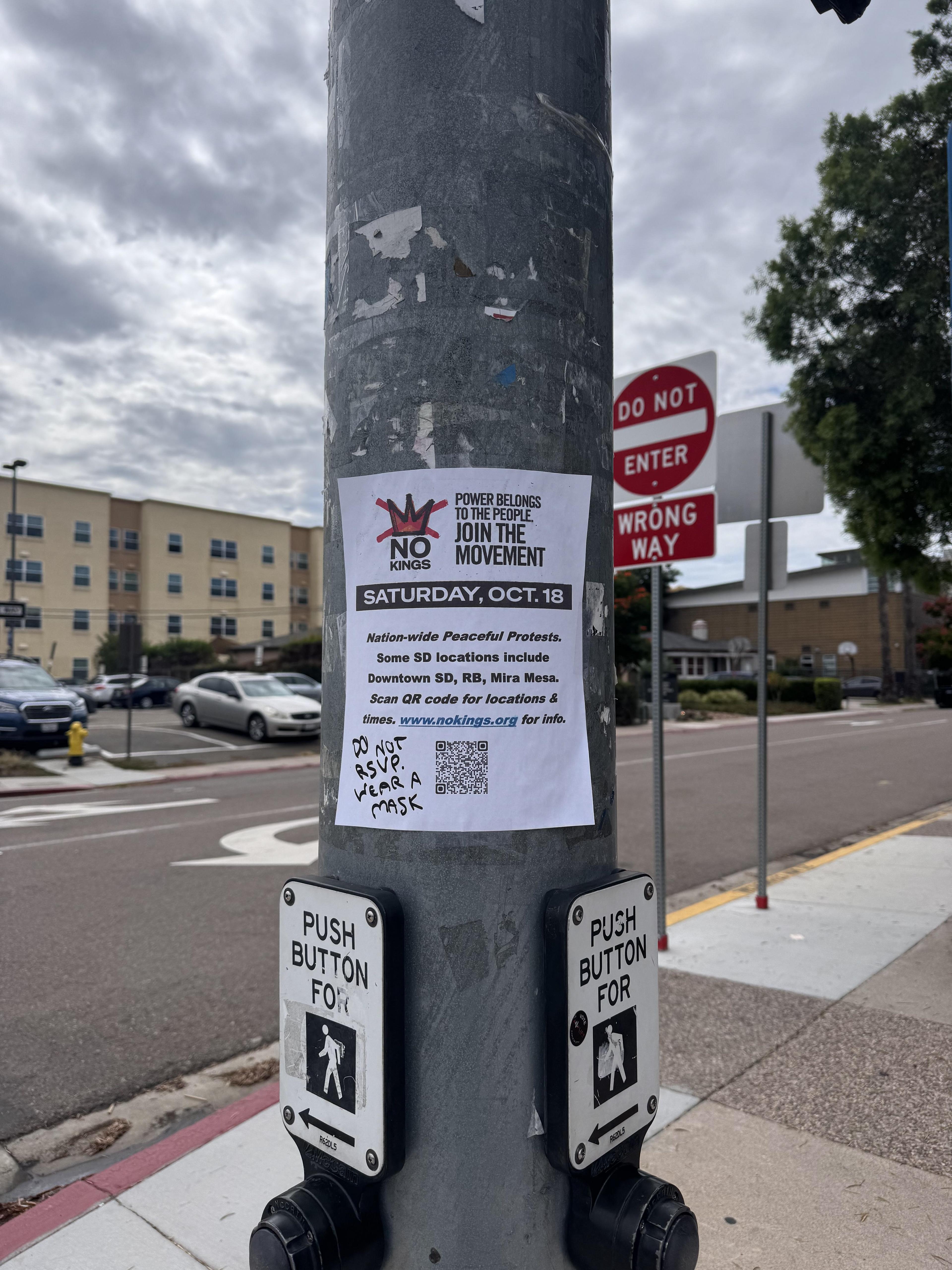   A flyer on the corner of Campanile Drive and Hardy Ave. on SDSU campus announcing the No Kings Protests. Photo credit: Catherine Curley