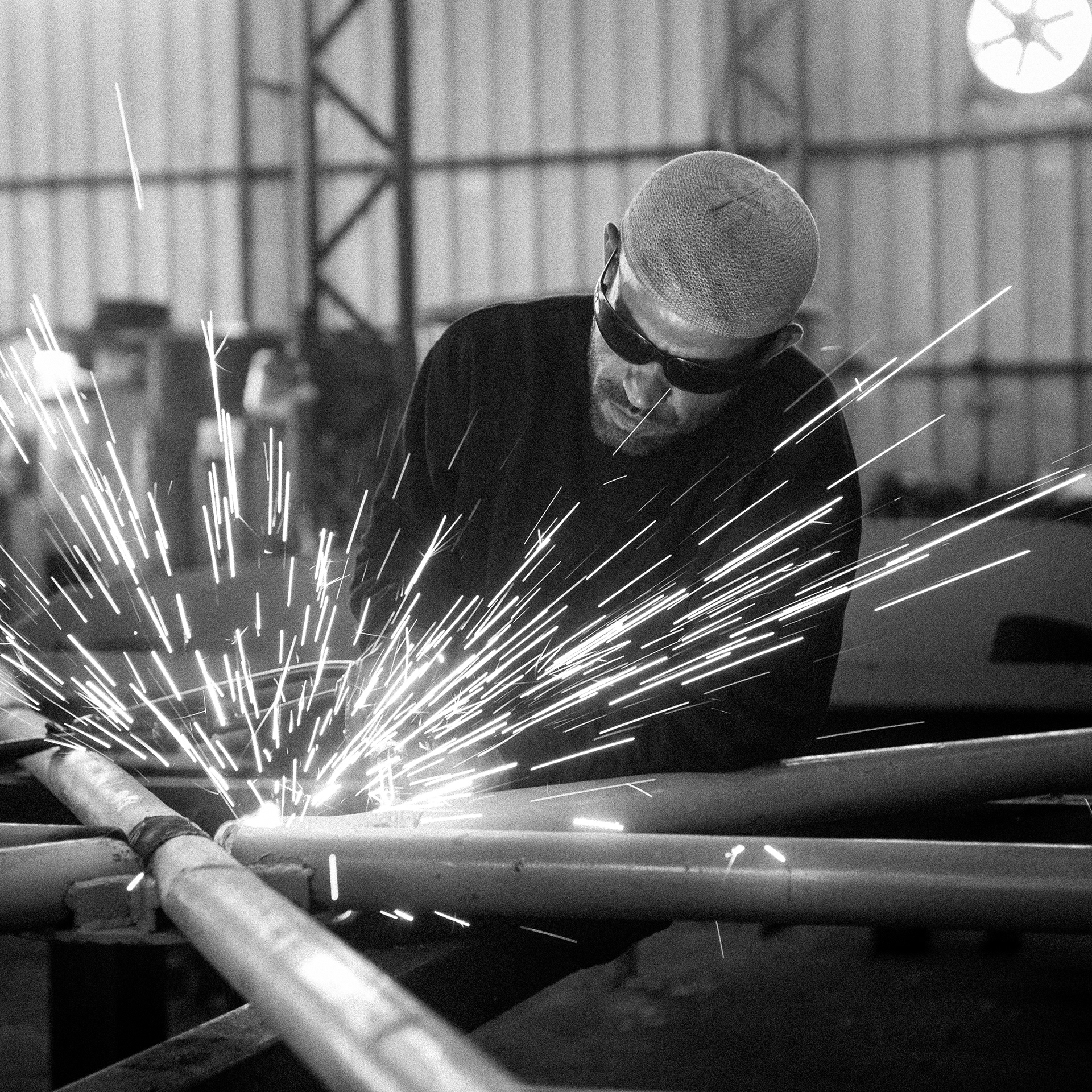 Locksmith bedouin is cutting a metal construction with the gas cutter