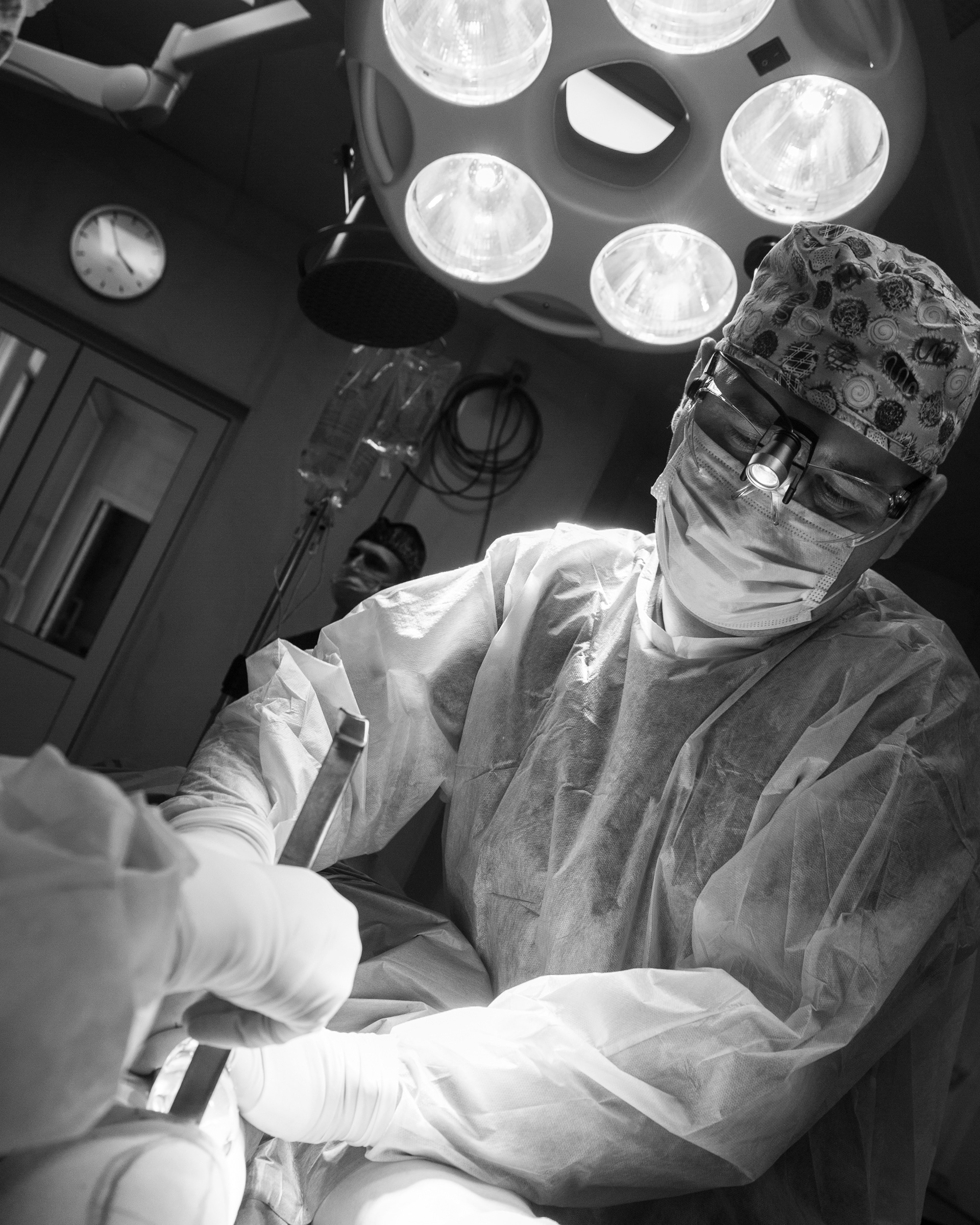 A surgeon is installing implants in the calf