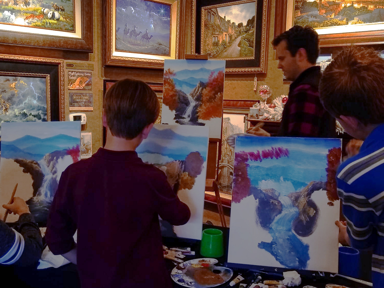 An artist-led winner experience · Children painting with a participating gallery artist