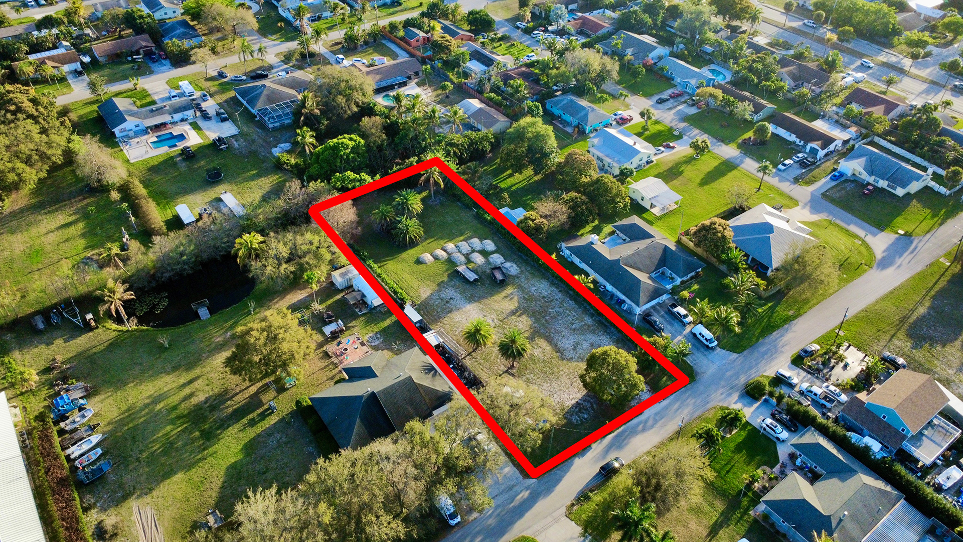 Neighborhood aerial showcasing surrounding homes, street layout, and overall community environment.