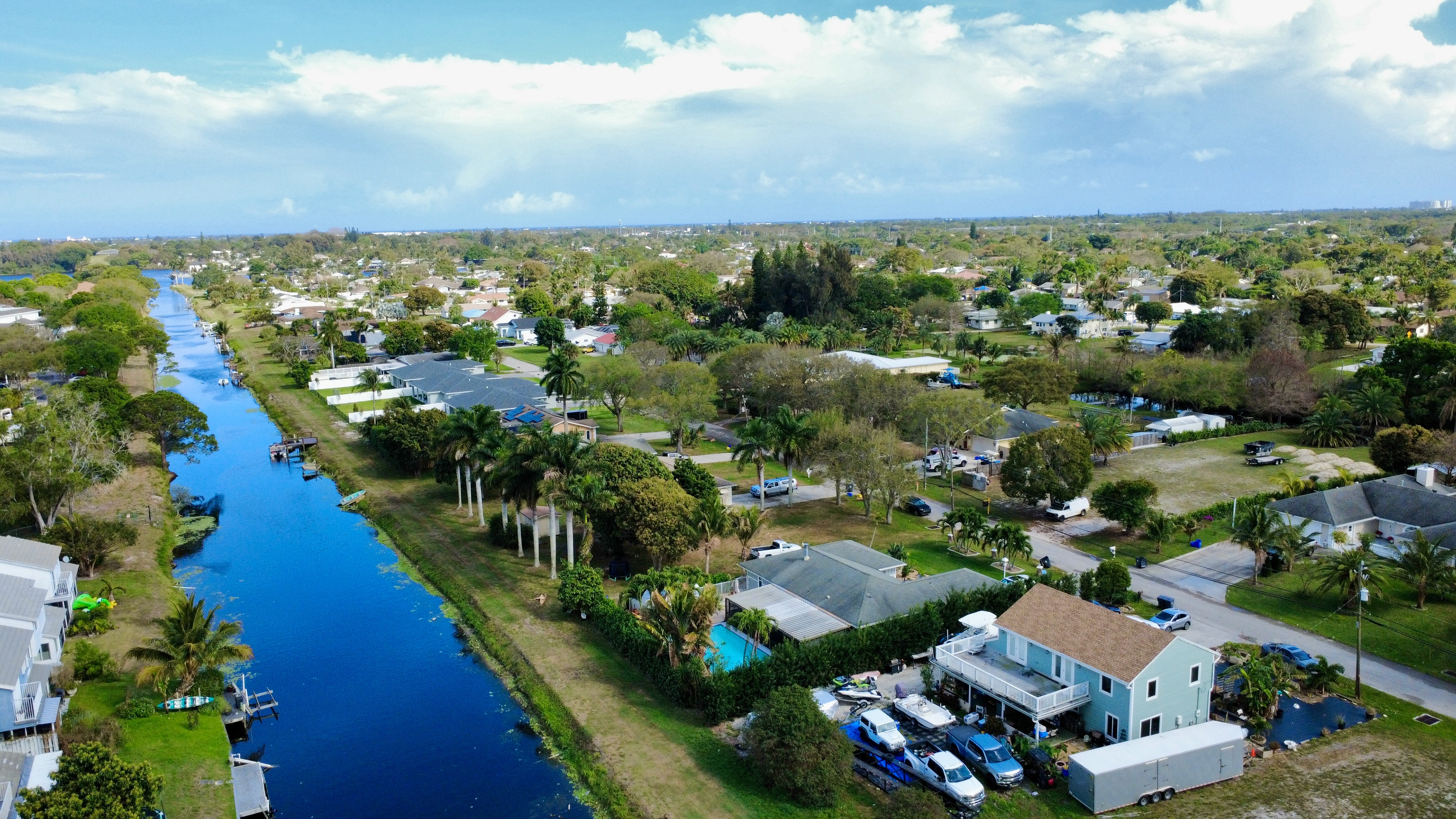 Palm Beach County waterfront aerial capturing neighborhood layout, canal access, and surrounding residential.