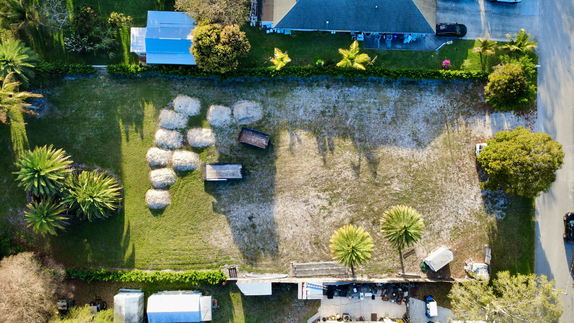 Aerial composition capturing the entire property footprint including parking, access, and exterior features.