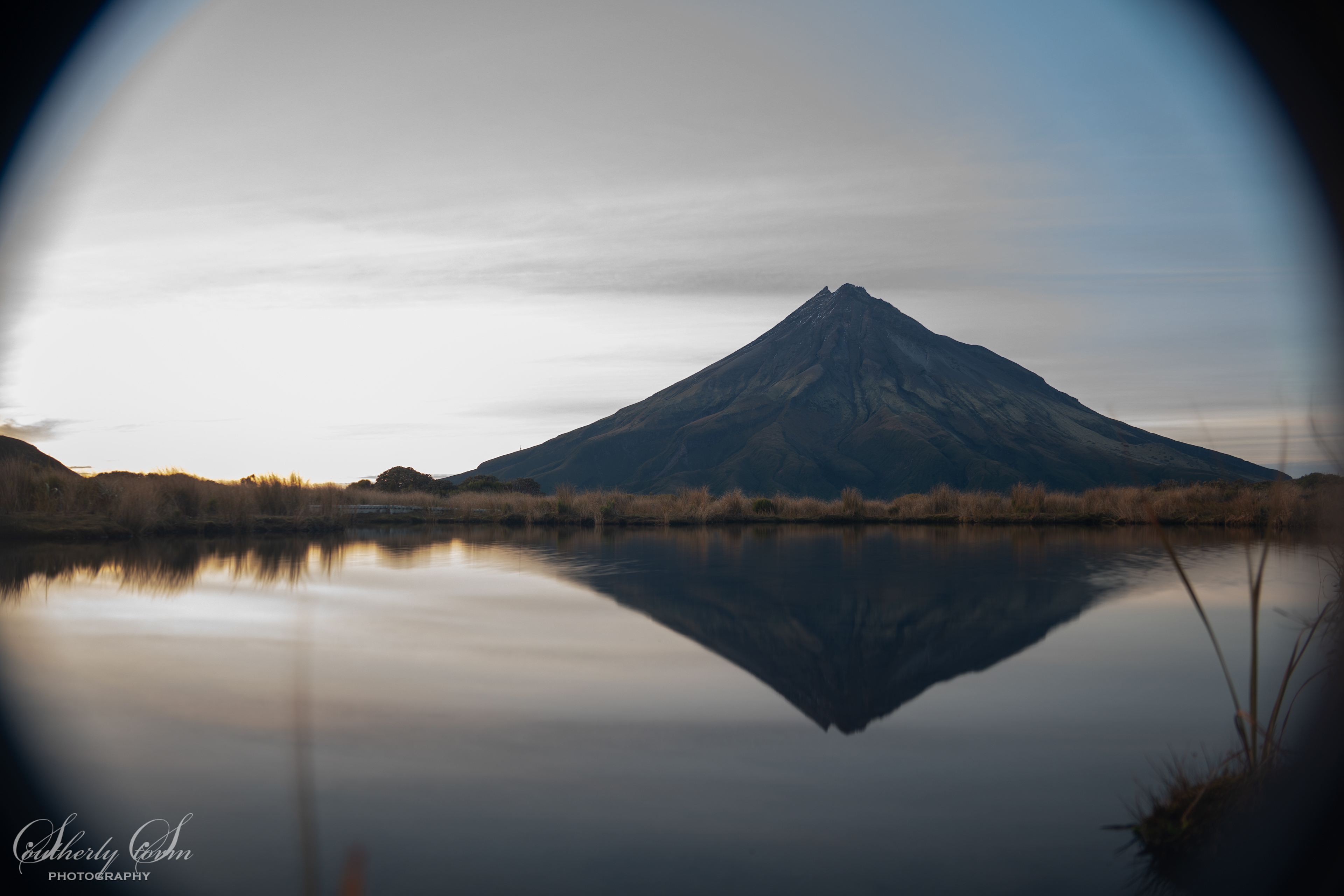 Vignette of Mt Taranaki and Pouakai Tarn reflection at dawn