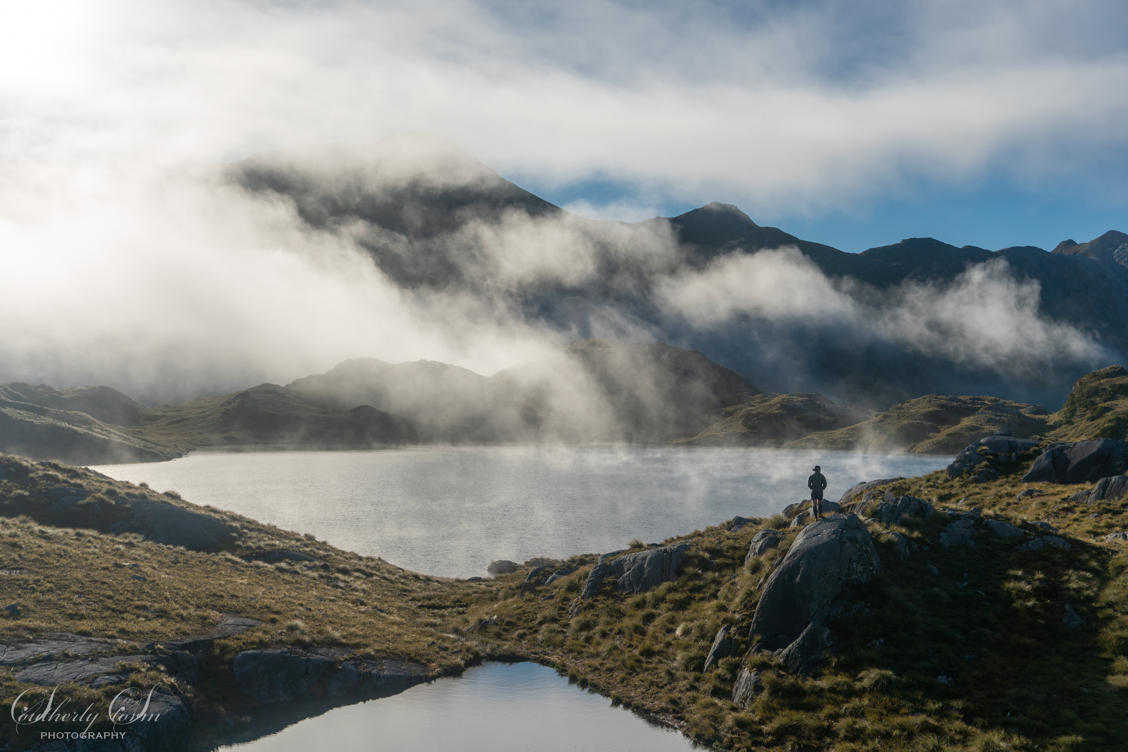 Lone tramper by Lake Roe