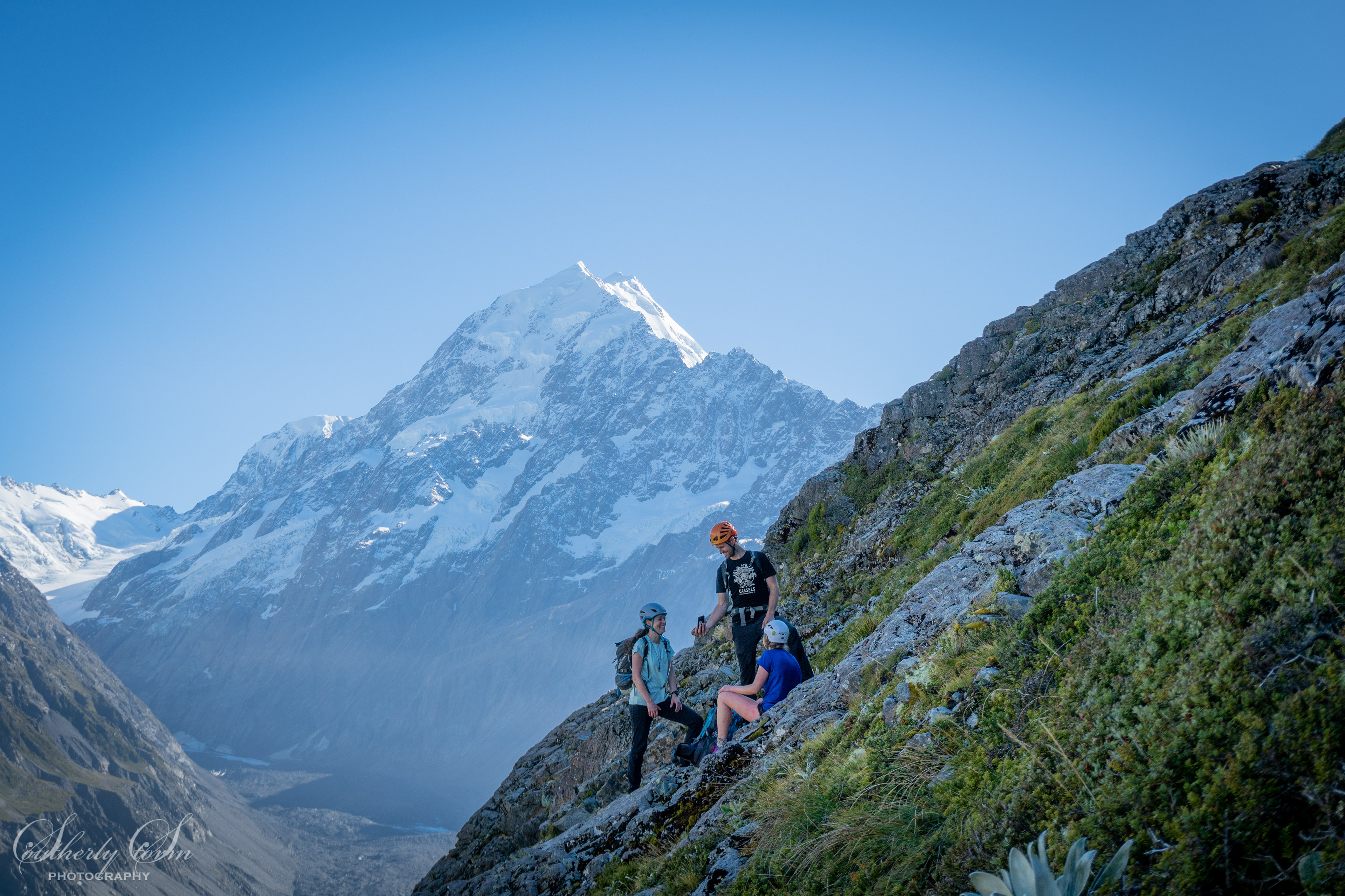 Three climbers on guideless butress with Aoraki Mt Cook in the background