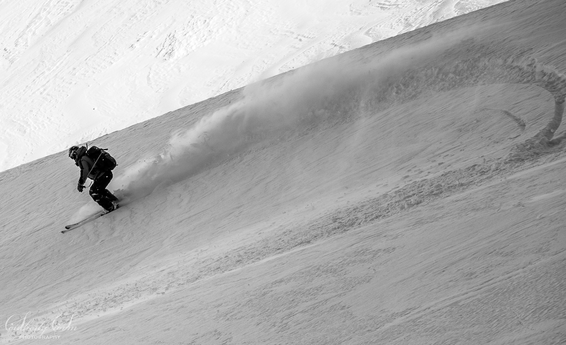 Black and white photo of a skier in motion
