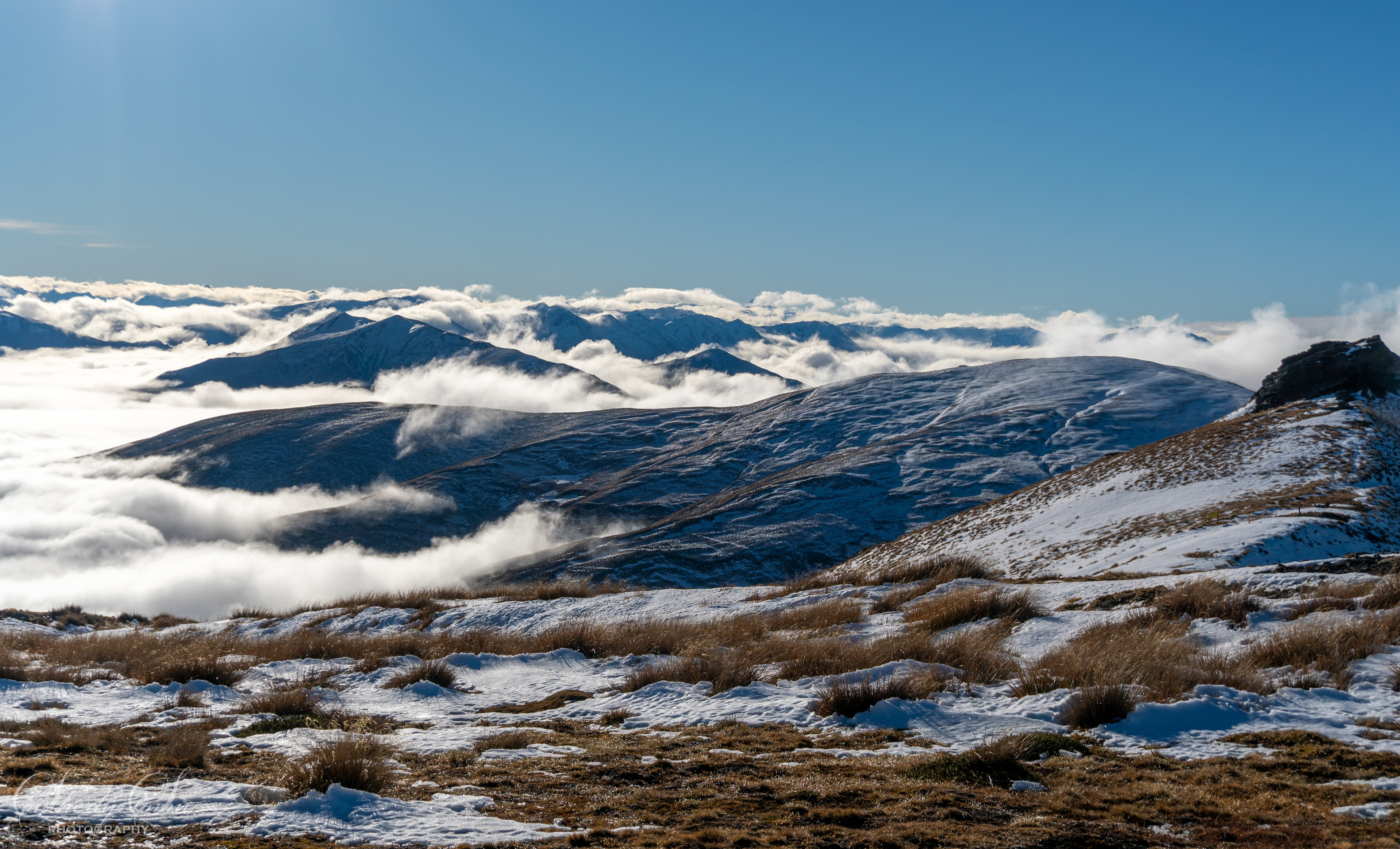 Scenic clouds, snow and tussock