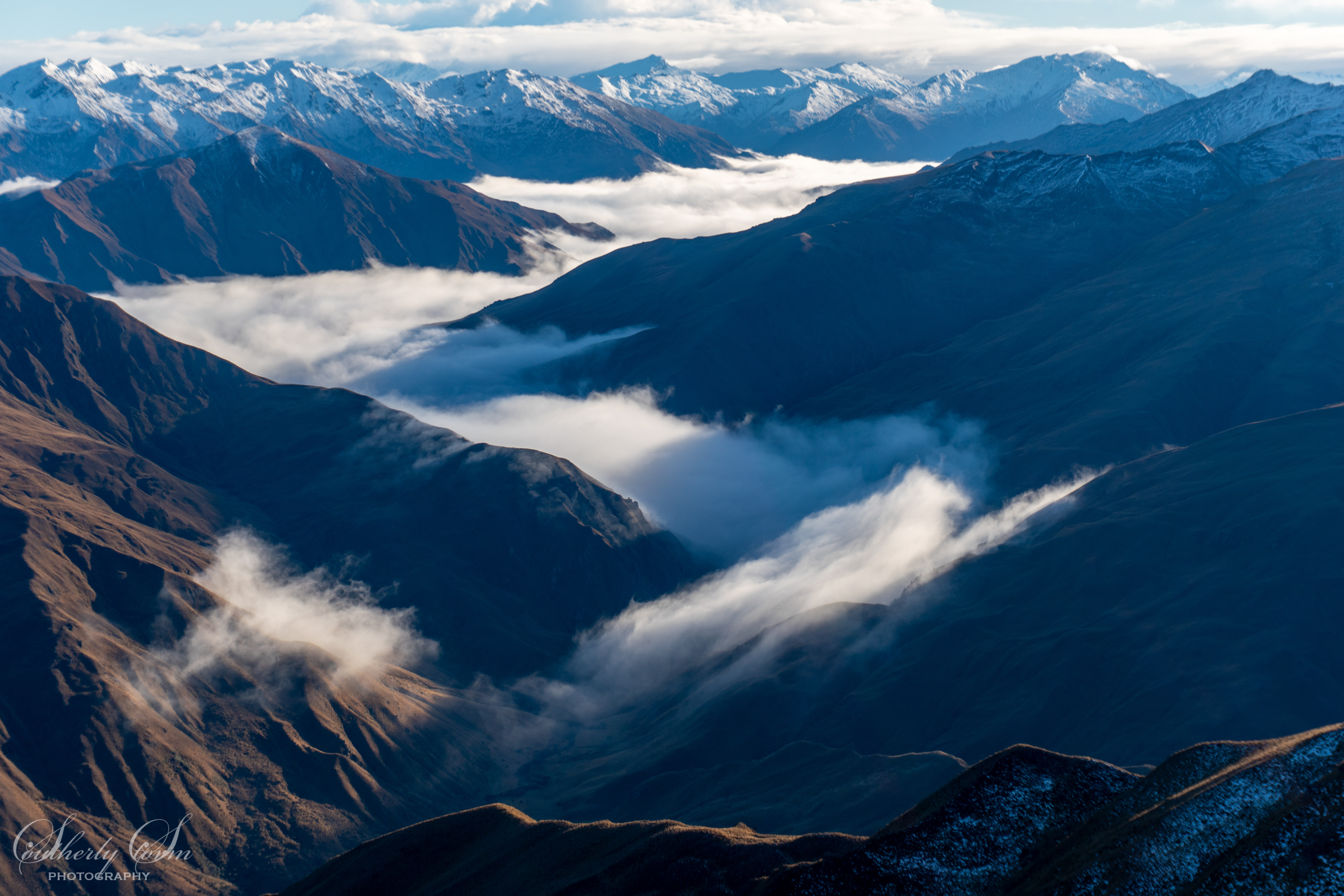 Cloud flowing down a classic Central Otago Valley
