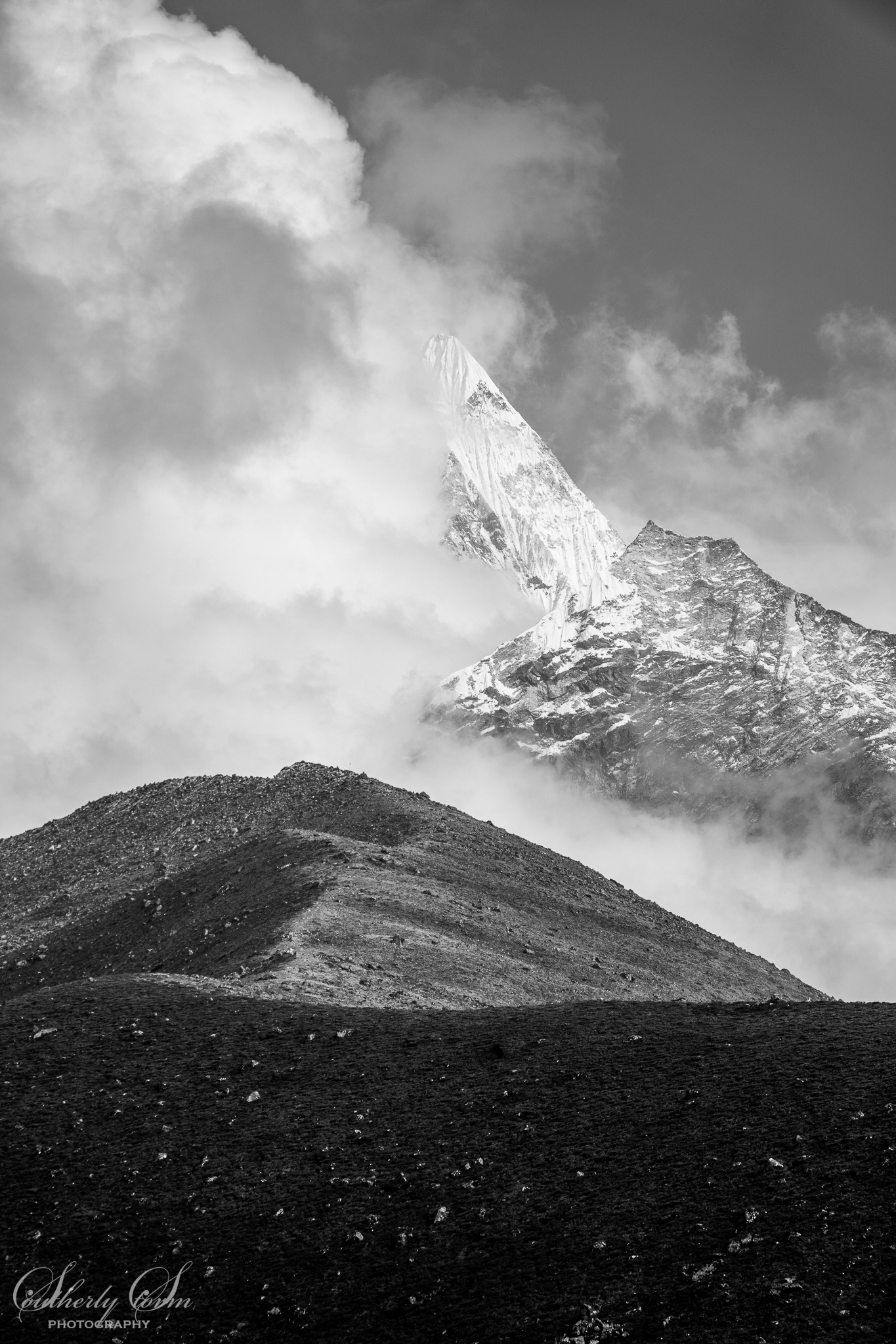 black and white photo of ama dablam in cloud