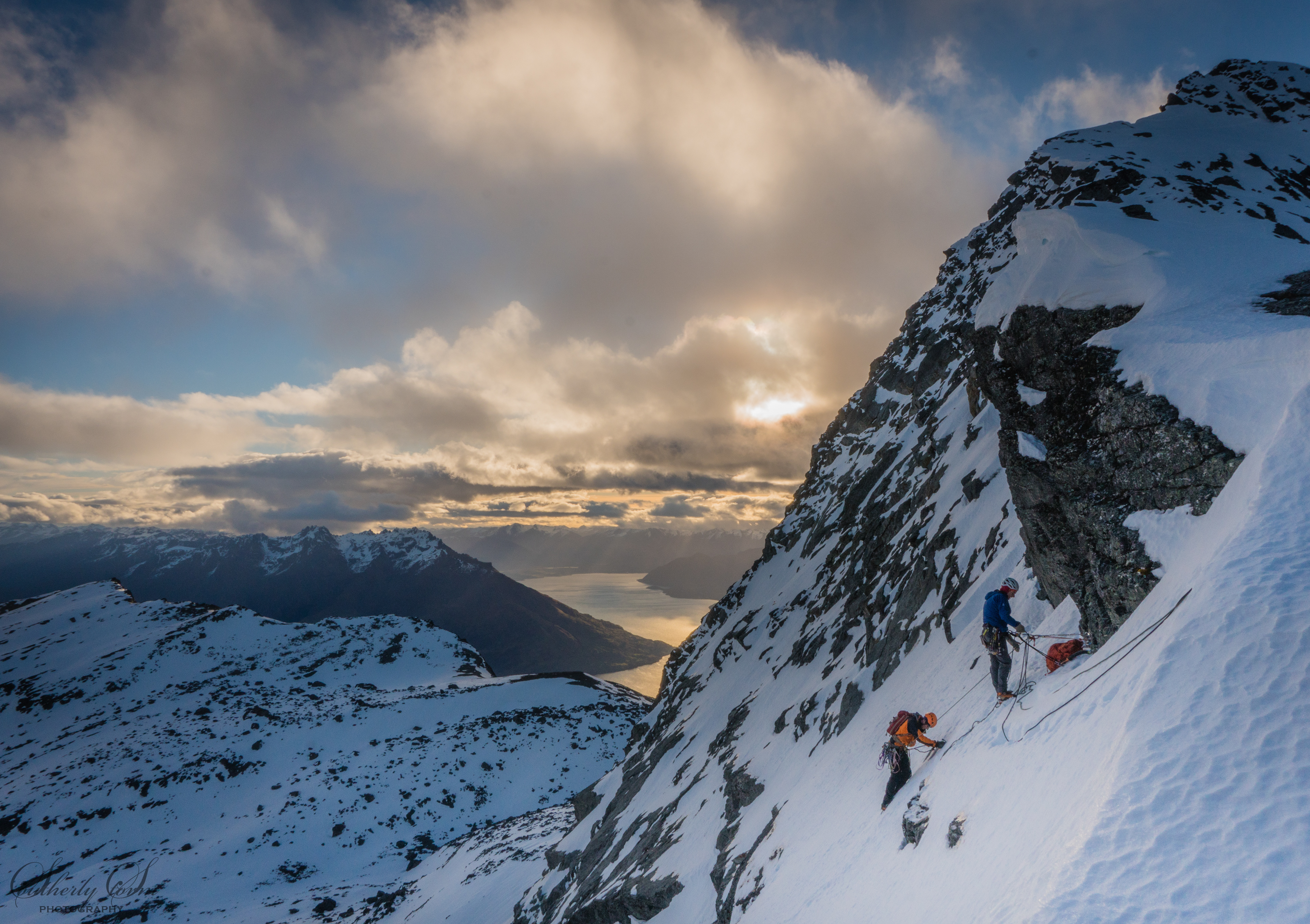 Climbers climbing the south face of single cone, the remarkables