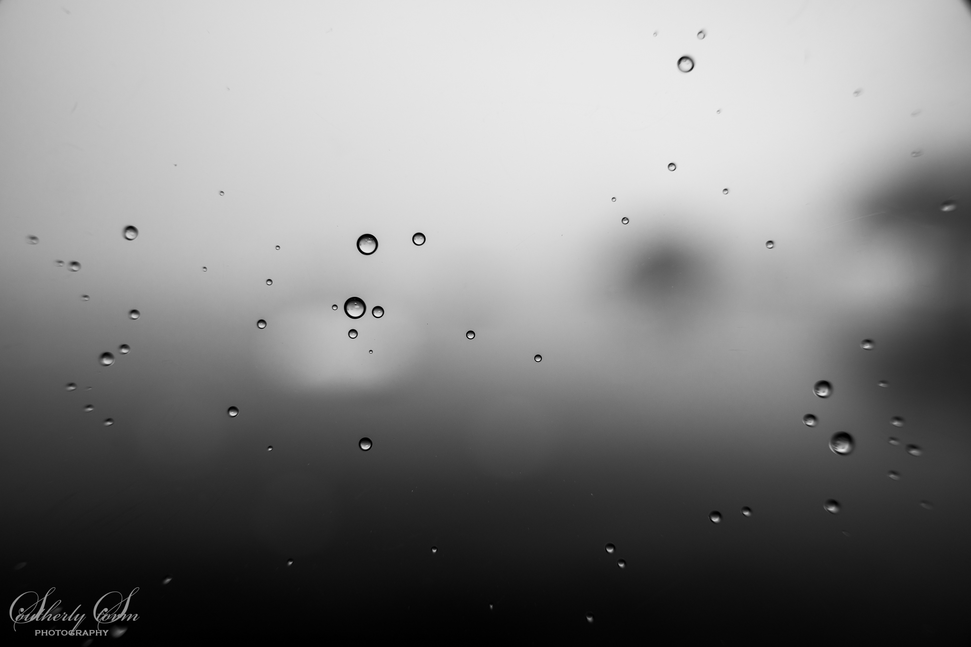 Black and white water droplets on the camera lens