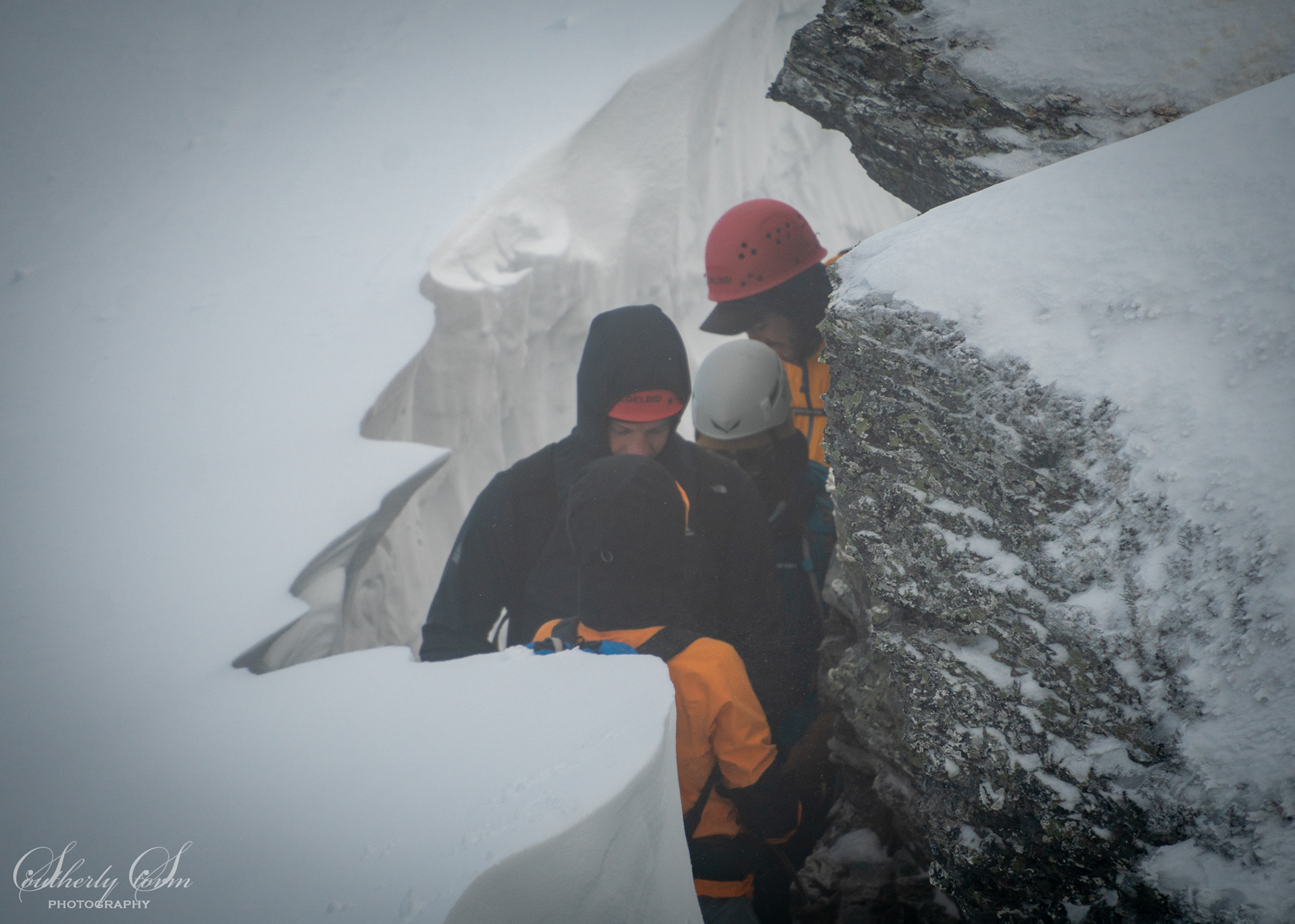 People between snow and rocks
