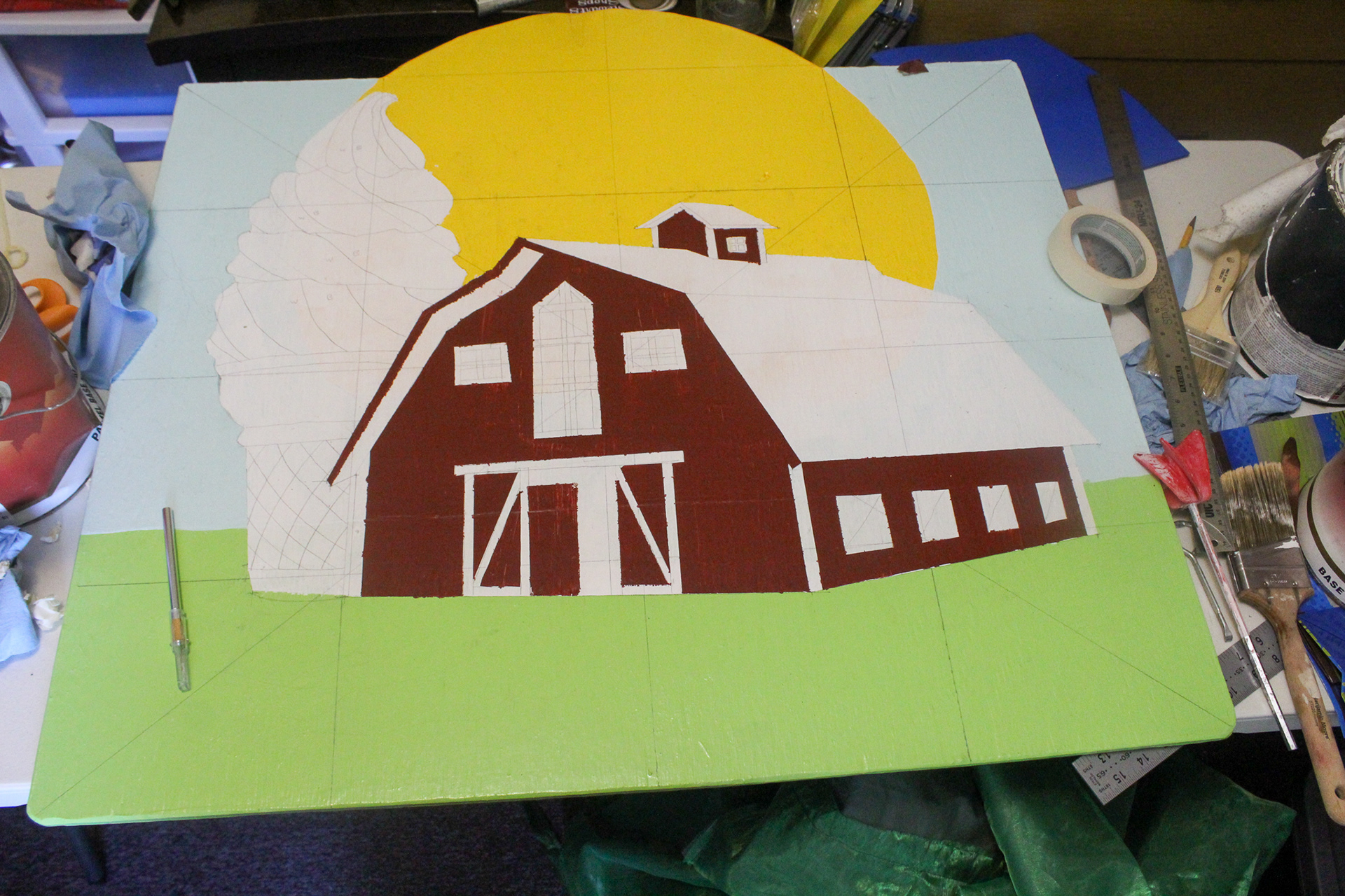 After tracing the image in based on the points I plotted from the grid, the methodical taping and painting of each color layer began.