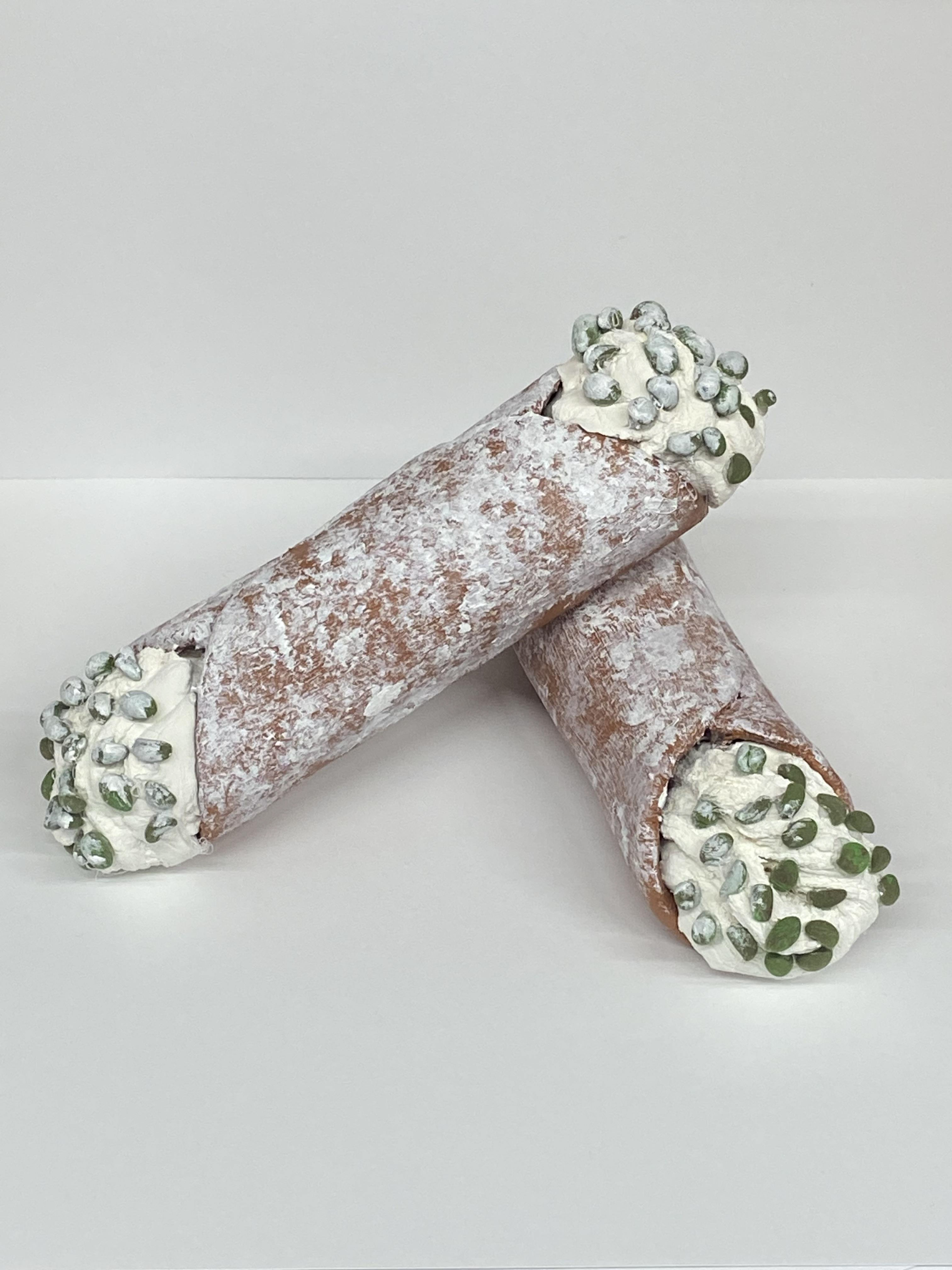 Gabriella Trujillo Created cannoli’s out of model magic. I showed powdered sugar with white paint.