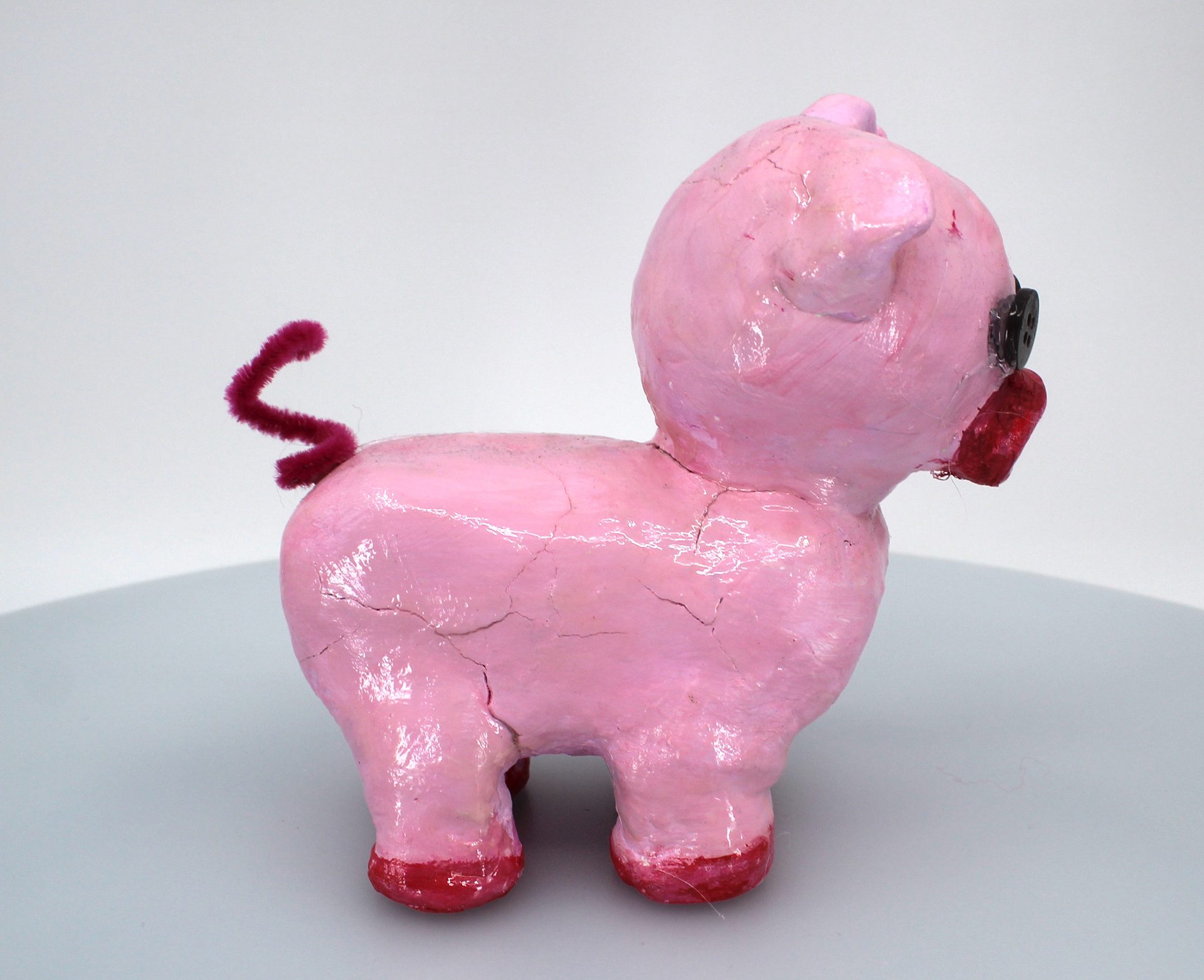 Jimena Taboada This pig sculpture is made out of air dry clay. I added these button eyes because they add something out of the ordinary of how pigs are usually created in art. I really wanted to make a pig because they have been one of my favorite animals since i was younger.