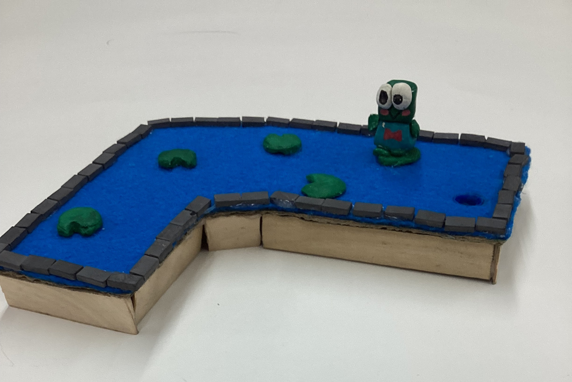 Maritza Valentin My artwork is a mini golf course based off of Keroppi from Hello Kitty. The idea behind it was to be a small frog pond.