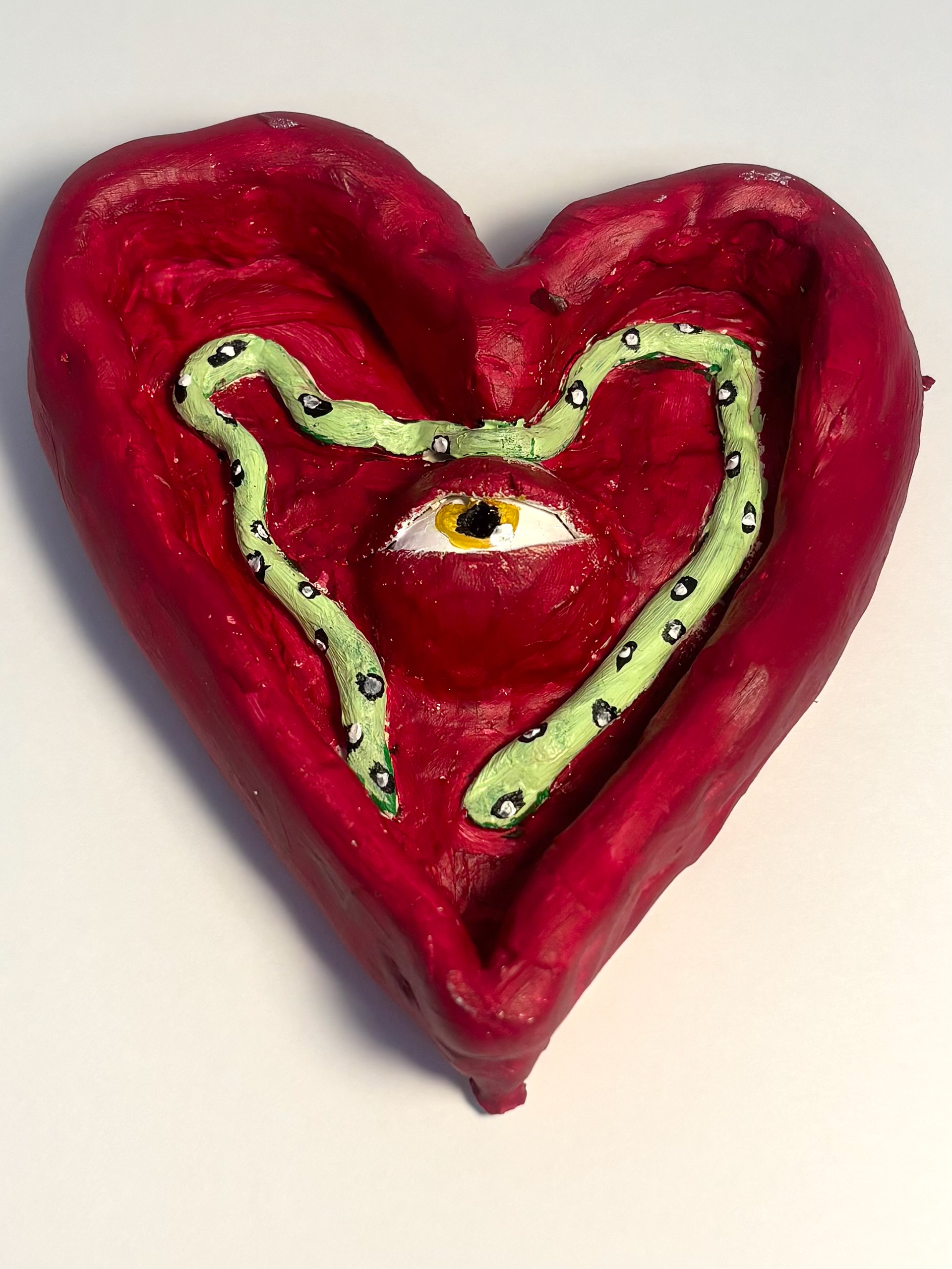 Jennifer Quinde I made a heart form and then I put an eye in the middle and a snake around the eye.