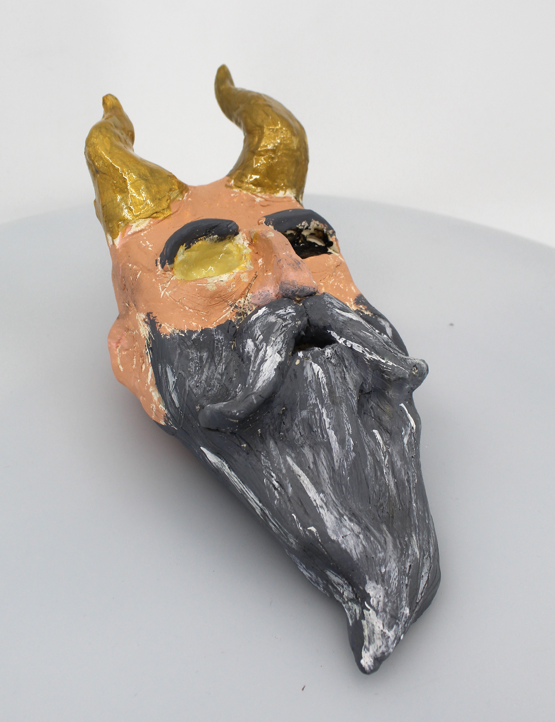 Jayvien Galeas I created the sculpture, based on Mimir from the God of War series, to captivate the very emotional character Mimir. Mimir is the decapitated head of the God of Knowledge from Scandinavian Mythos. The sculpture started as a ball of Air-dry clay, I would later add the beard, molding it to the main ball. After everything that I added, the last few steps were to add the horns and add the texture of the sculpture, and lastly the colors. Mimir is a beautiful character and a very well-written one at that, he is one of the few funnier side characters in such a bitter and unfriendly world, and I wanted to have a physical object that represents the well-beloved character and I'm glad it was made from my hands.