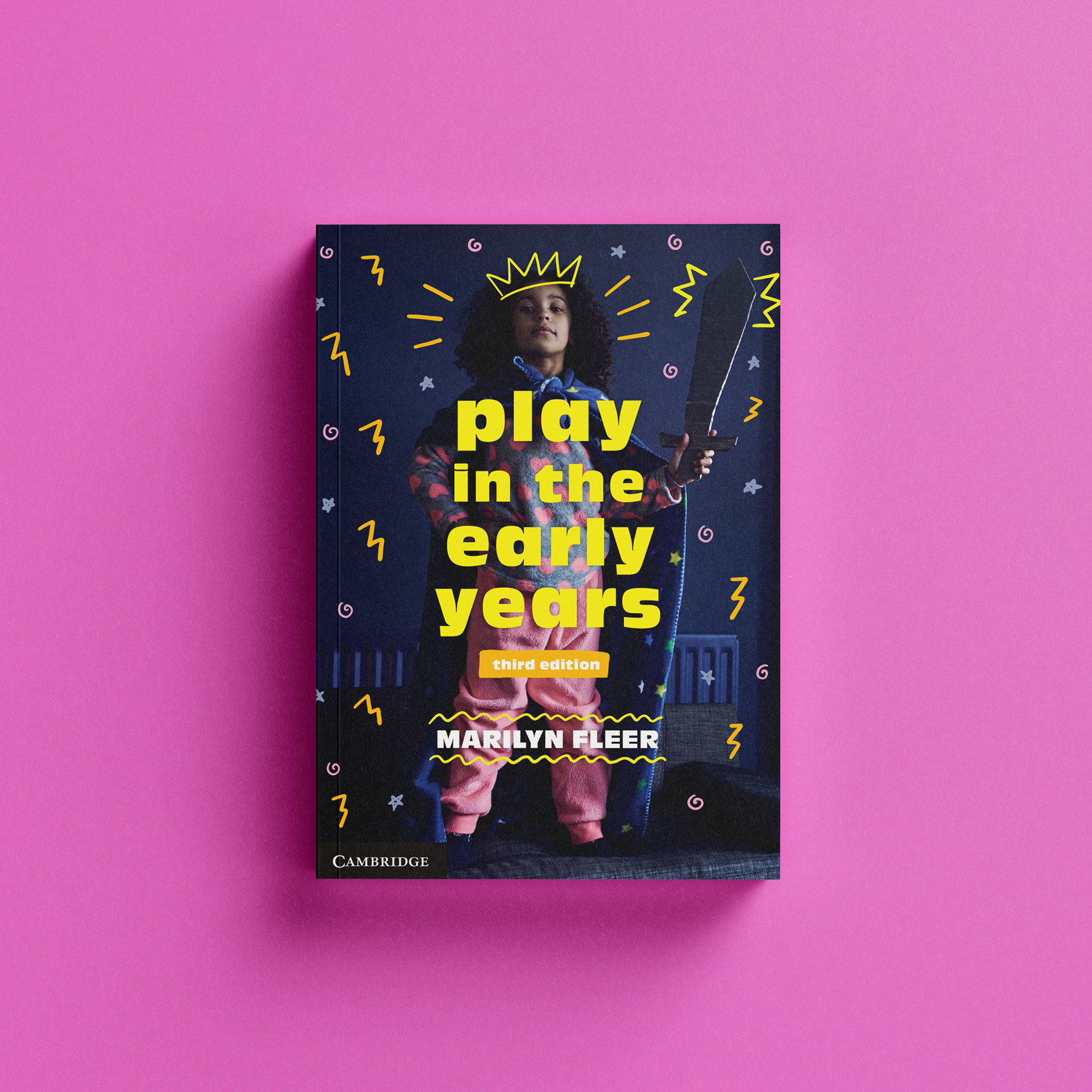 Book cover image showing a little girl with a blanket as a cape and a cardboard sword with colourful doodles of a crown and stars on top of the photo.