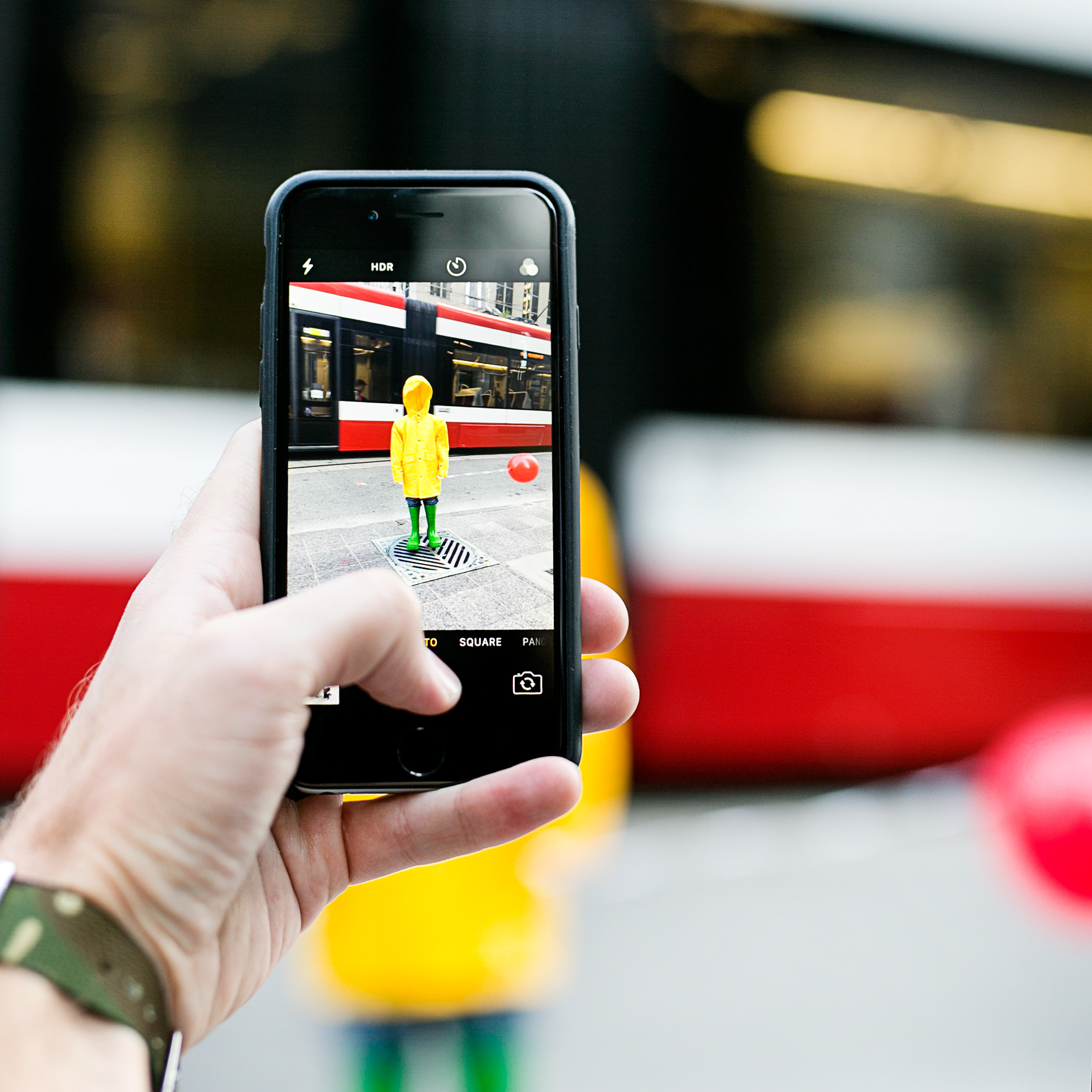 Man takes a photo of the #WheresGeorgieTO activation in Toronto.