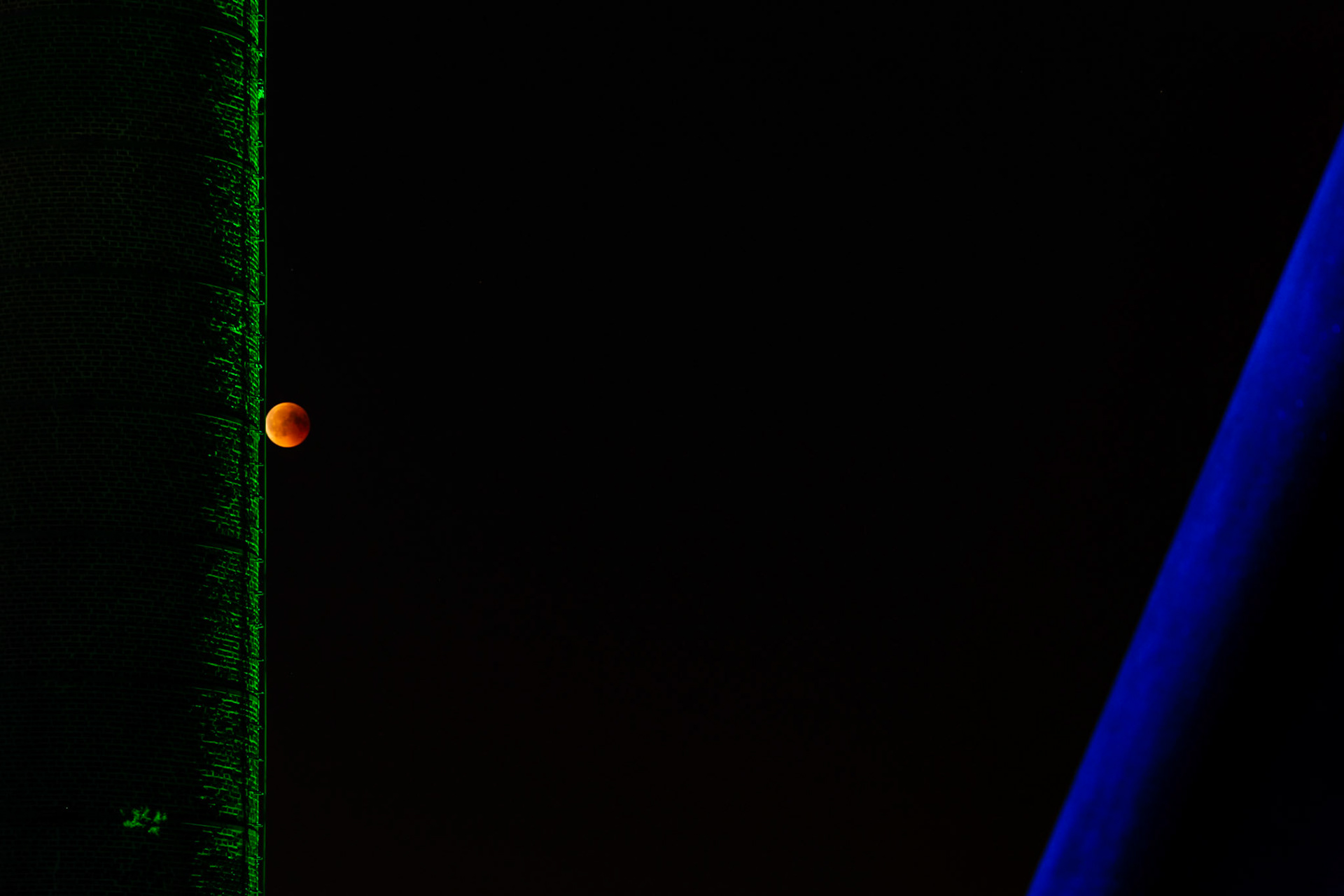A rare central lunar eclipse.  Totality lasted 1 hour and 43 minutes.The moon was near its farthest point from Earth and orbiting slowly, making it appear smaller and take longer to travel through Earth's shadow.  Earth was near its aphelion, the point in its orbit farthest from the sun, making its shadow appear larger.Although no longer directly illuminated by the Sun, the Moon still catches light filtered and bent by the Earth's atmosphere. This gives it an orange, brown or red colour, the "blood moon".