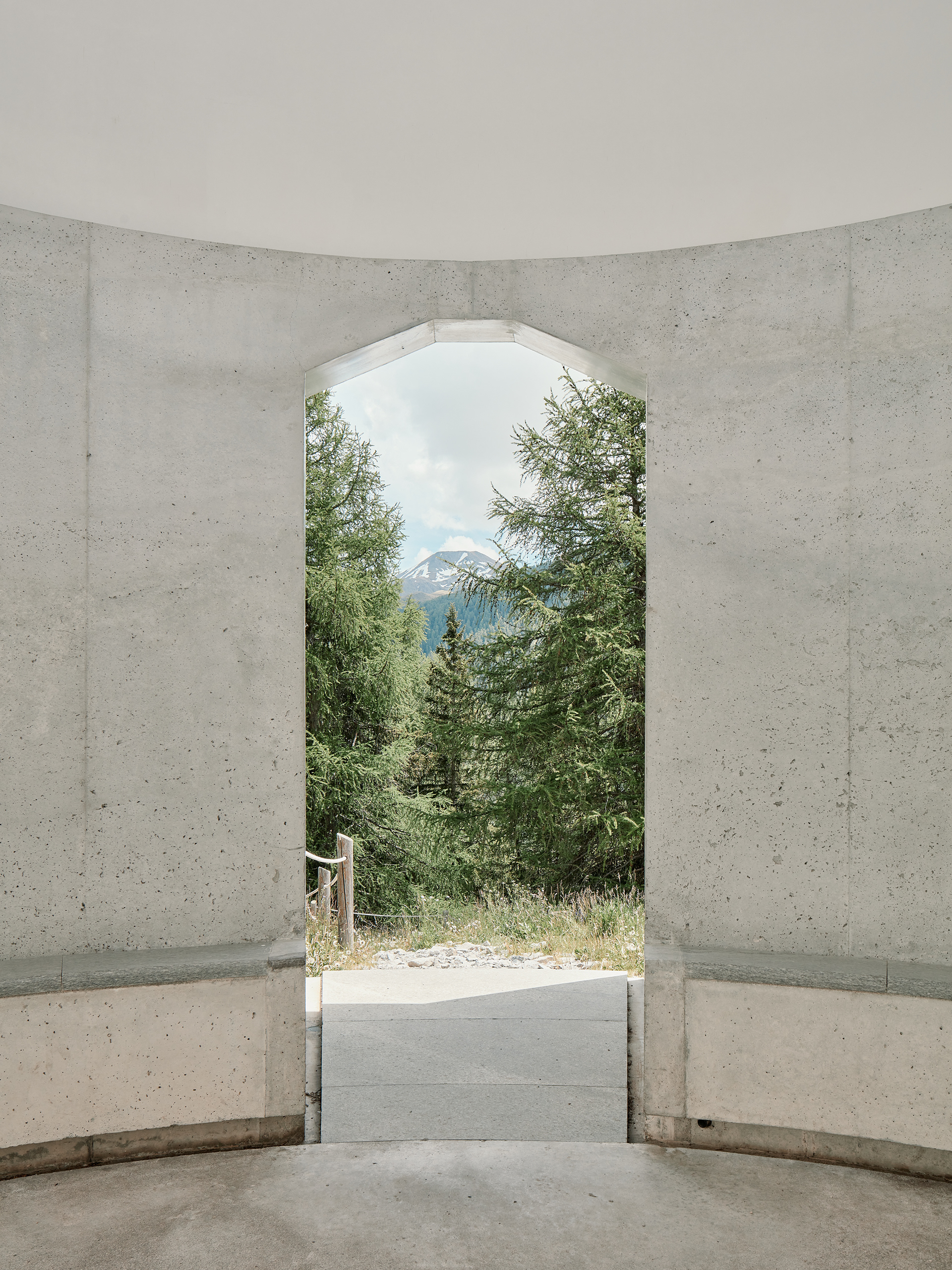 Close up of the entry - showing the view out onto the landscape with name-giving Piz Uter in the background - of James Turrell's Skyspace next to Hotel Castell in Zuoz, Switzerland.