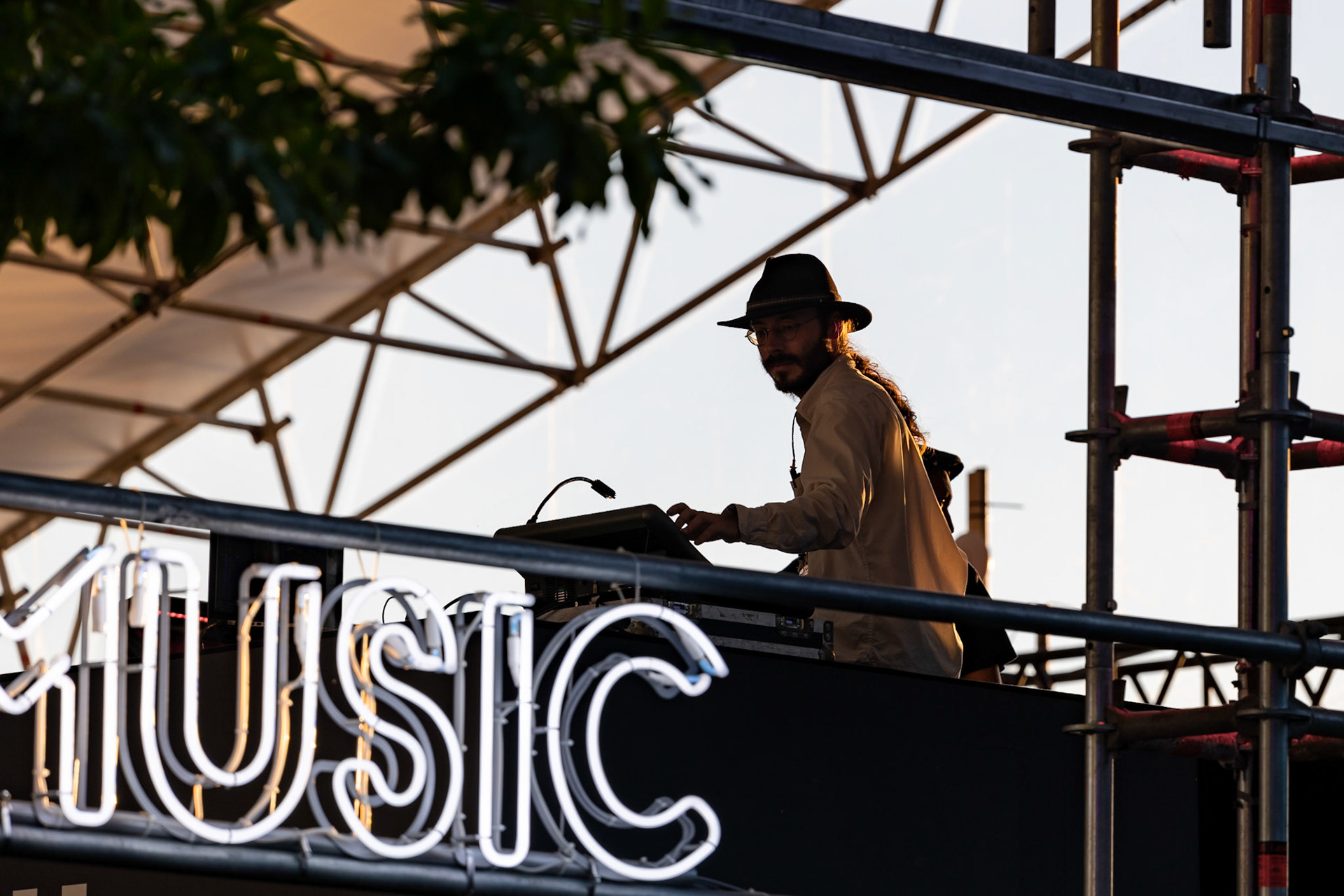 A performer at Montreux Jazz Festival 2022. There is a sign reading "music".