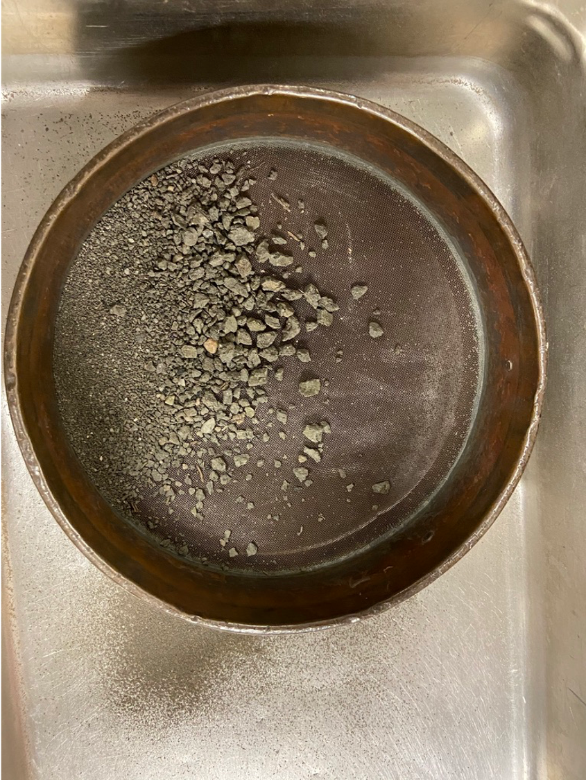 Sample from Longborough location being sifted into sand. You can see the sample had rocks in it as well.